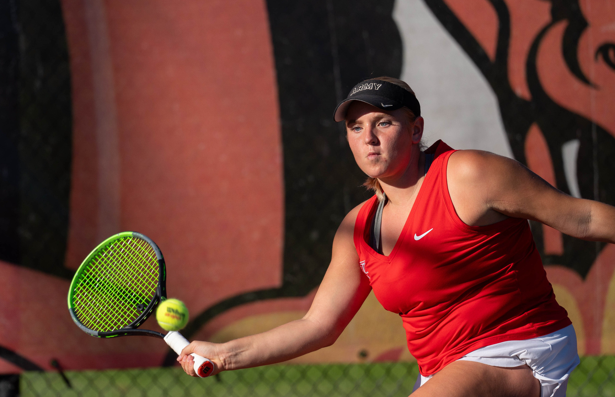 Haley Peck returns a shot against Cortland