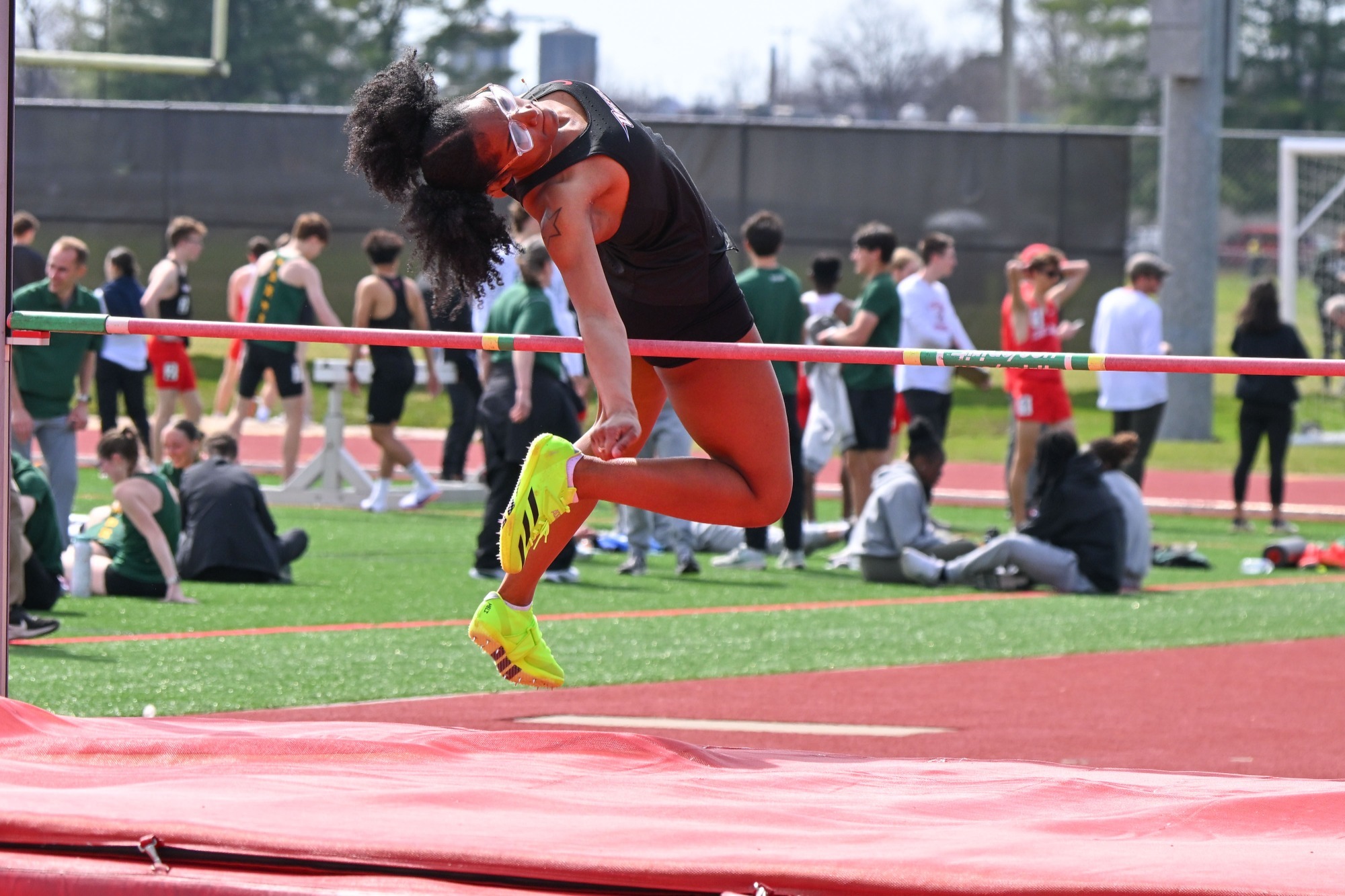 Melinda Reid jumping over the bar in the high jump at the Cortland Red Dragon Open