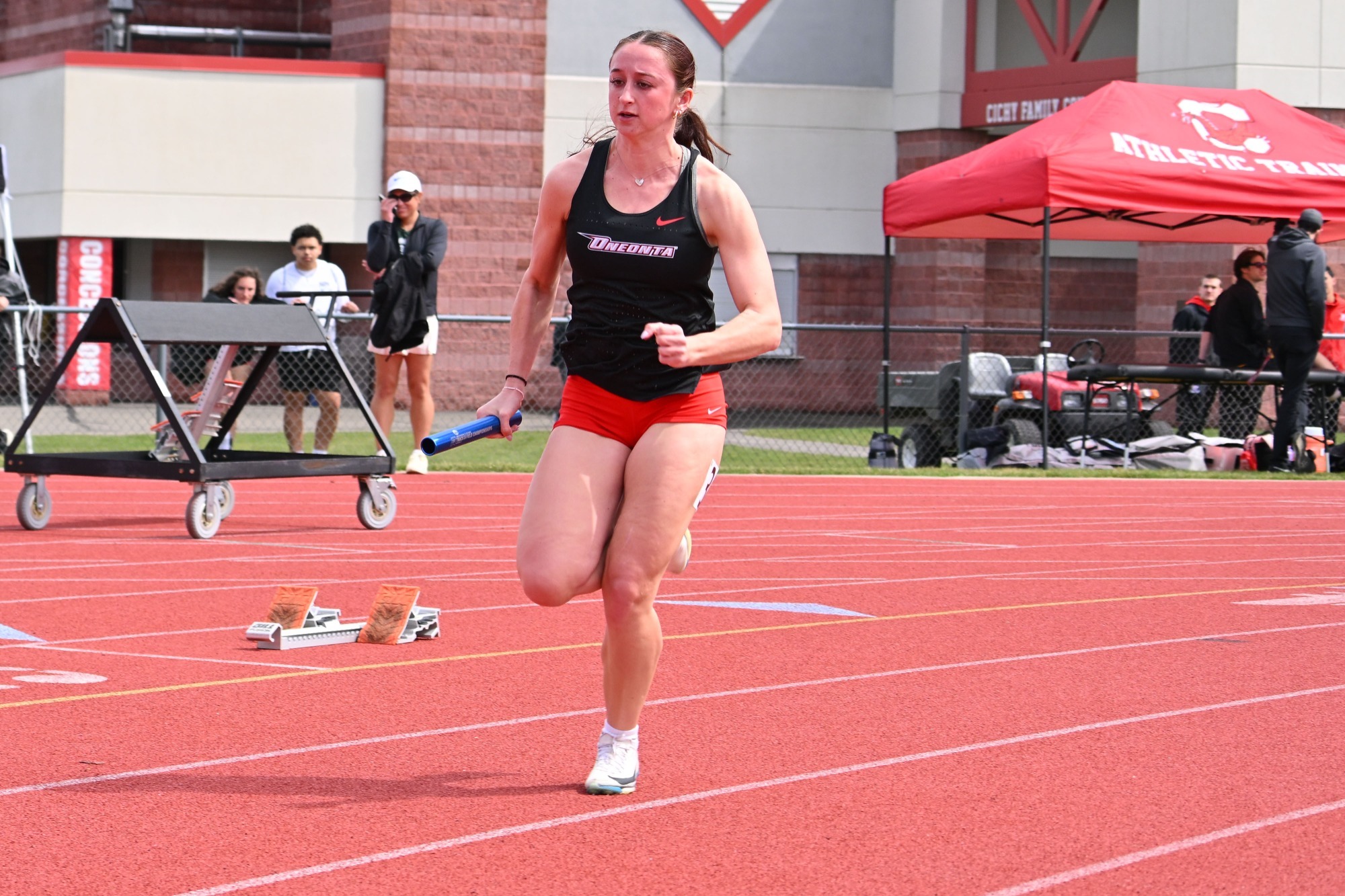 Jaiden Schrag with the baton during a relay at the Cortland Red Dragon Open