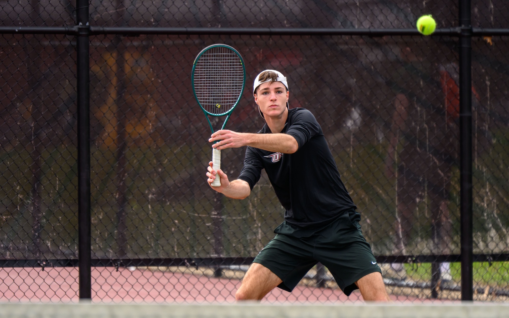 Chris Chippari returns a shot against Farmingdale