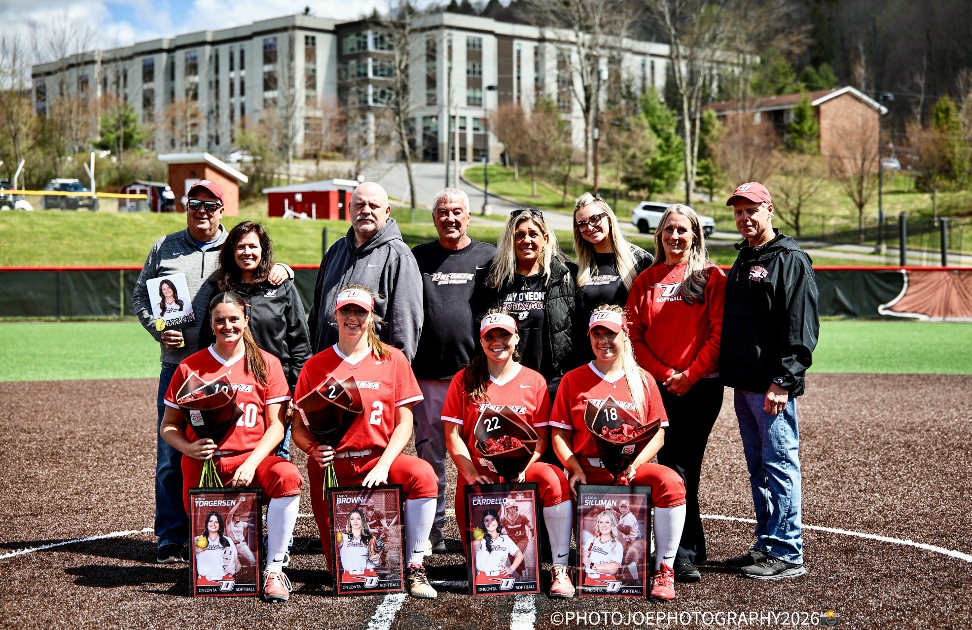 Softball's 2026 seniors take a group pic with their families for Senior Day