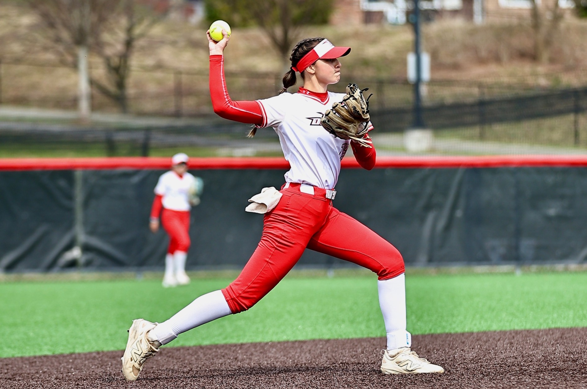 Ella Kean throwing to first base against Buffalo State
