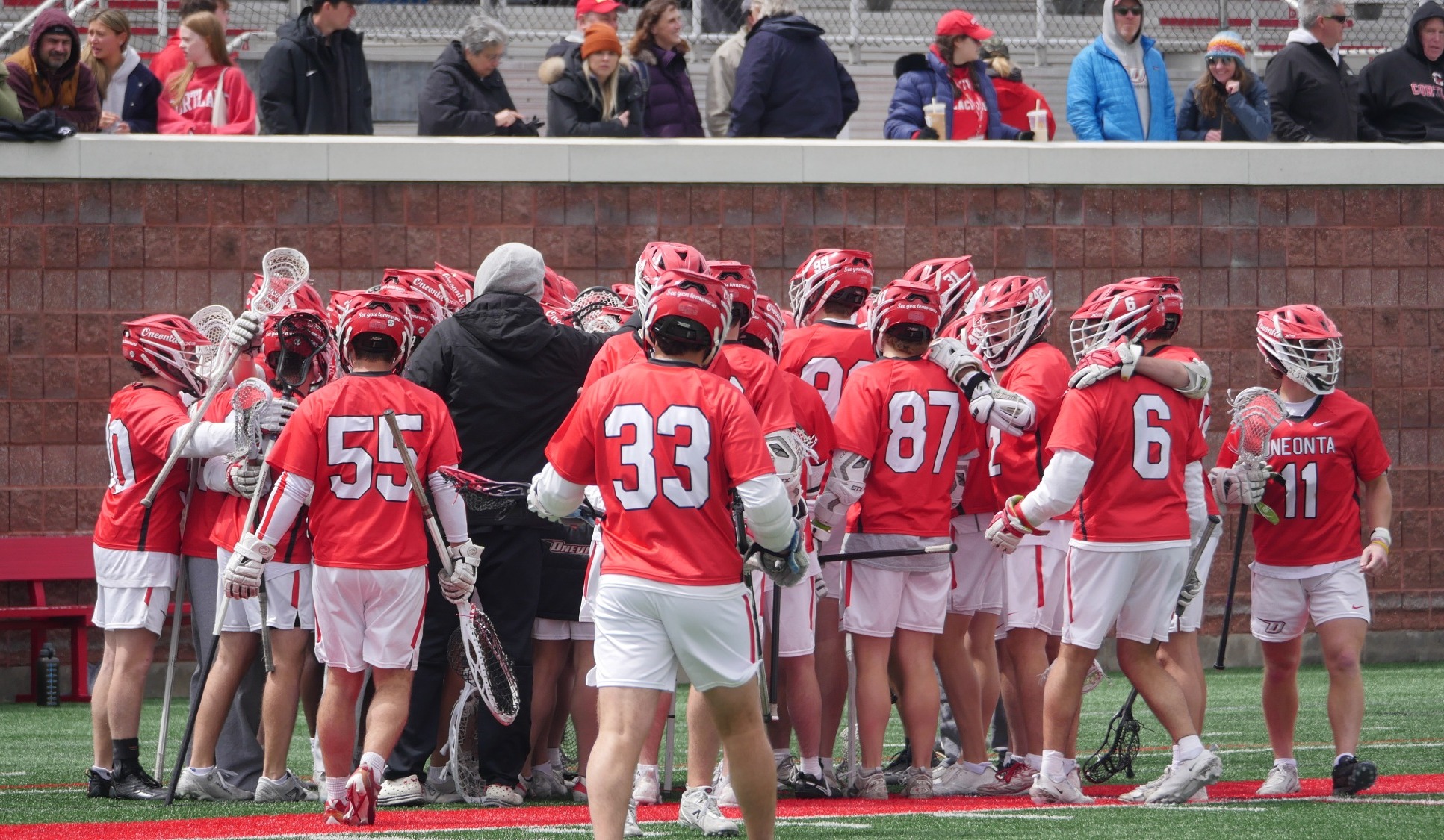 Men's lacrosse team huddles together at 2026 SUNYAC Championships