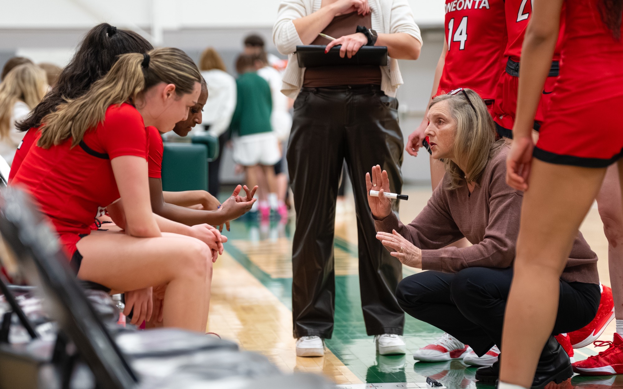 Daphne Thompson coaching in a team huddle
