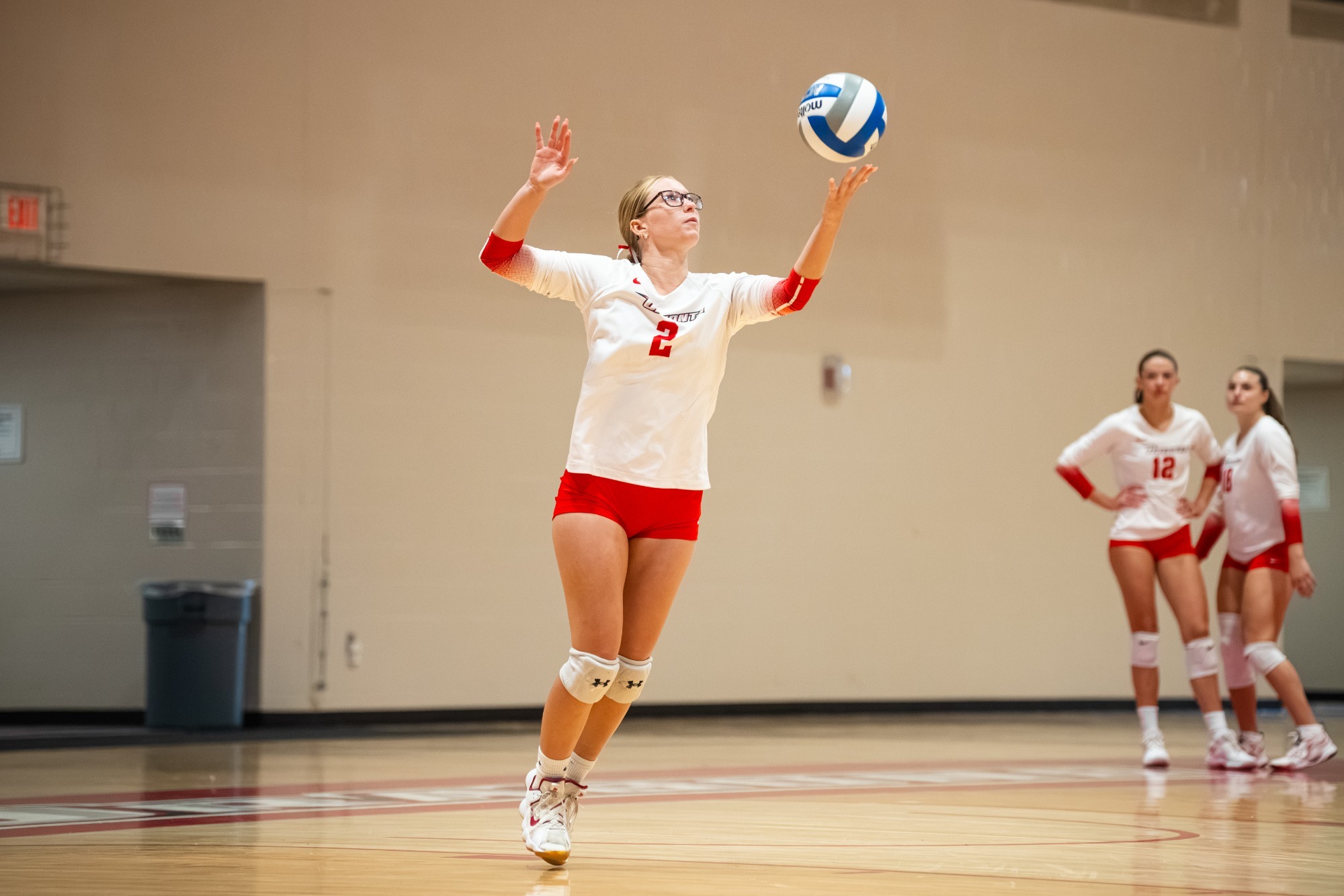 Lillian Slattery tosses the ball up to prepare for a serve