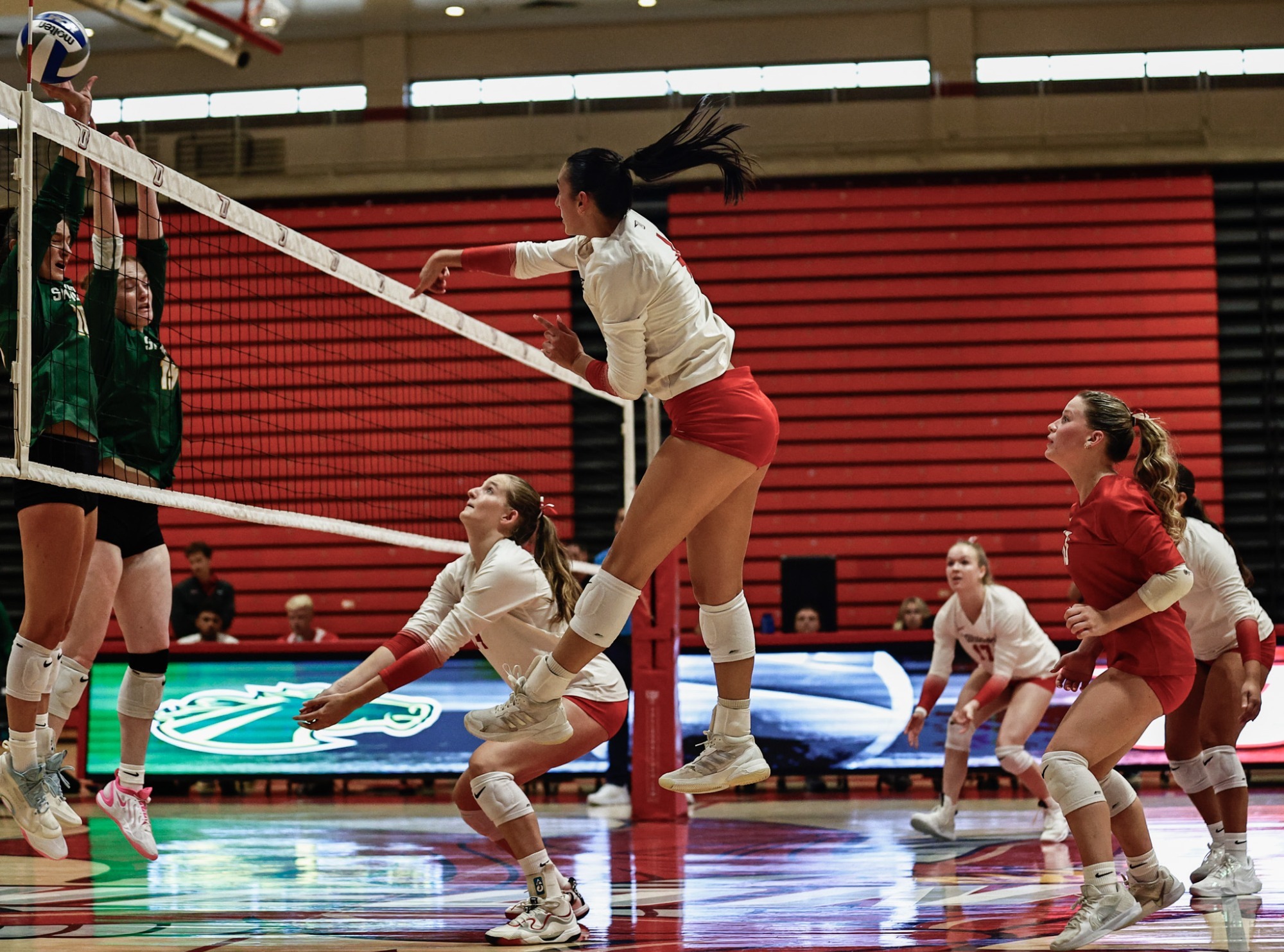 Corynna Manjos spiking the ball against Skidmore in 2026 season opening match