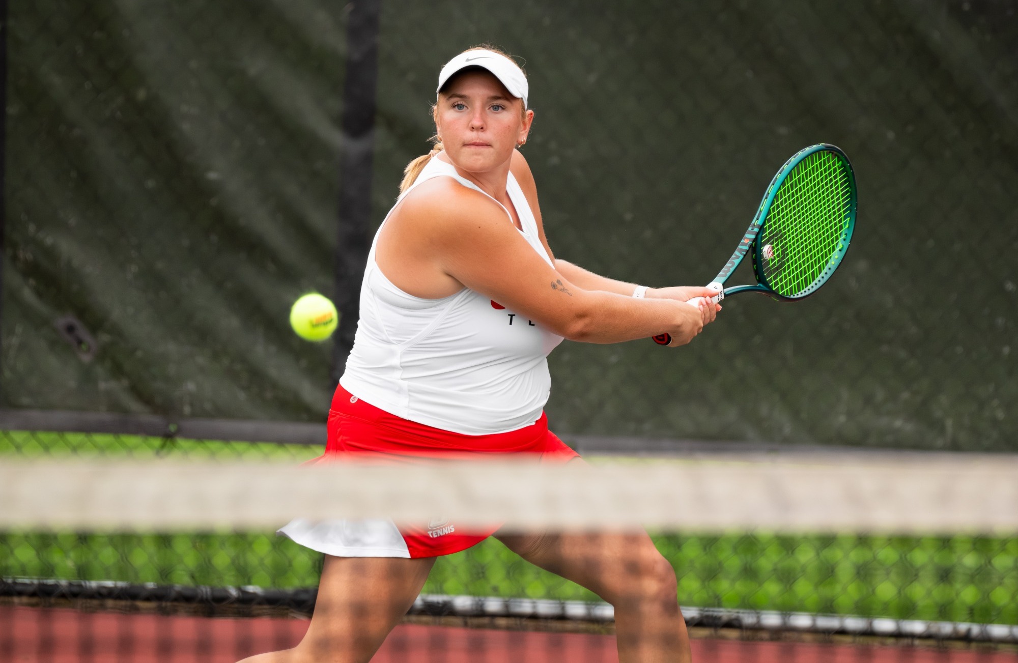 Haley Peck returns a ball in her singles win against Utica