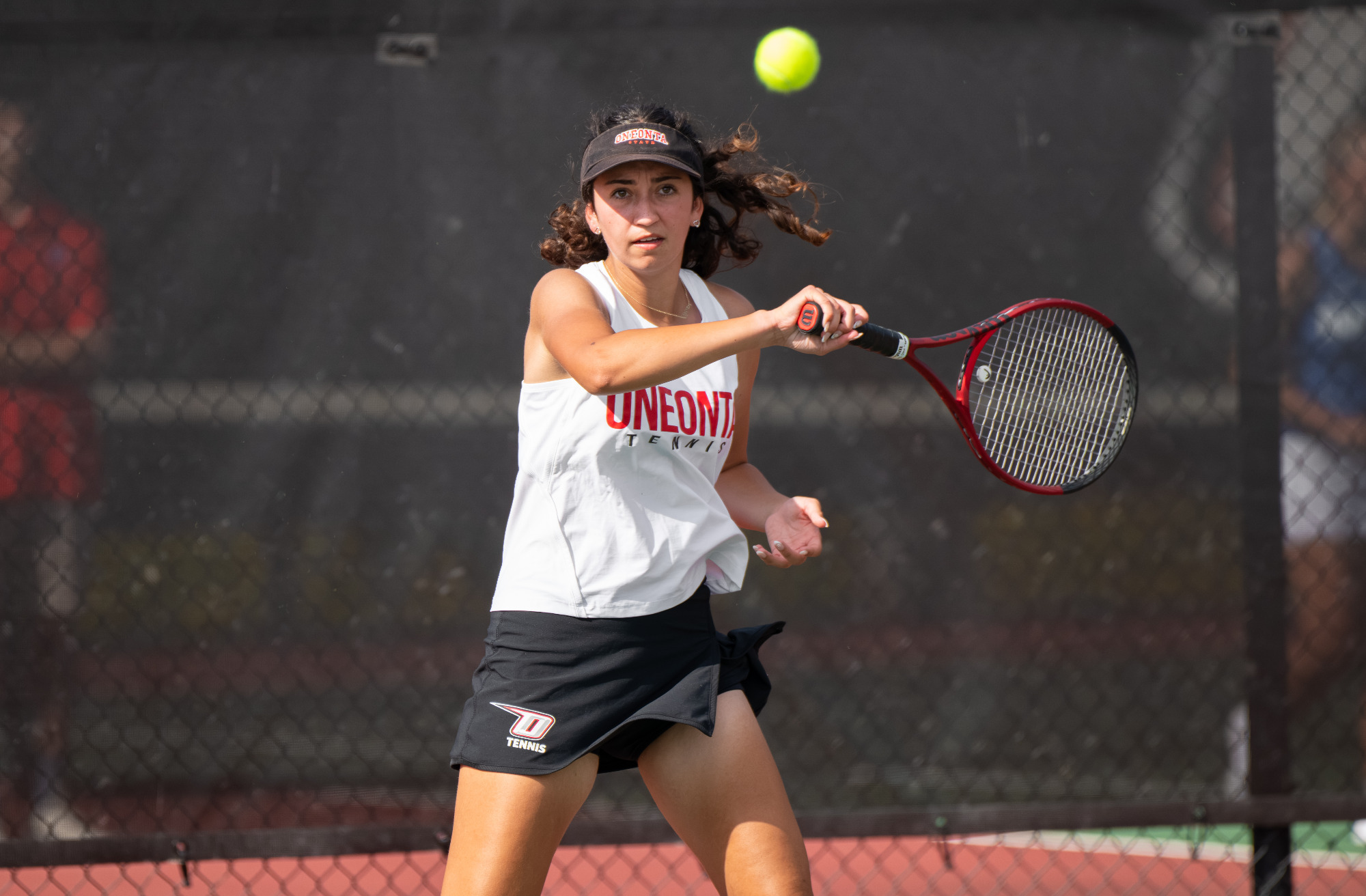 Dakota Jimenez returns a shot during her singles win against Hartwick