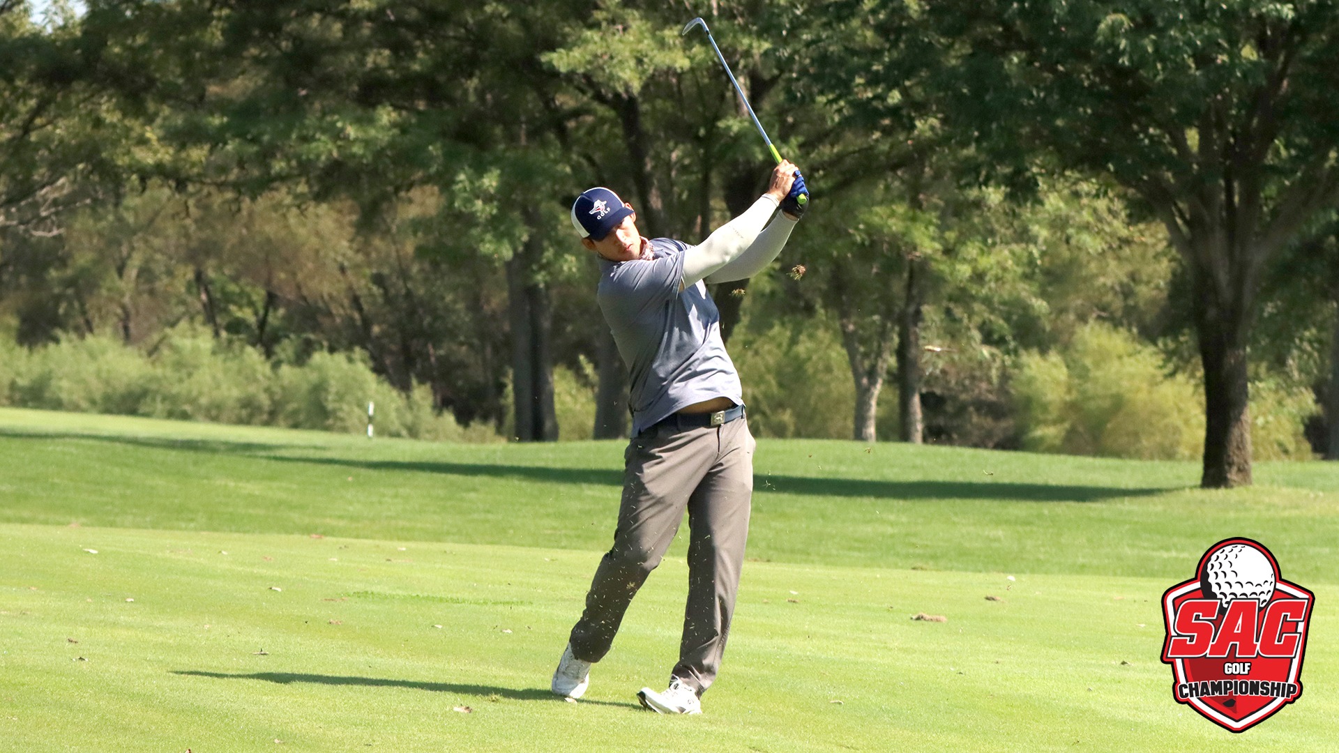 Saengvut hits iron shot off fairway SAC Champs logo