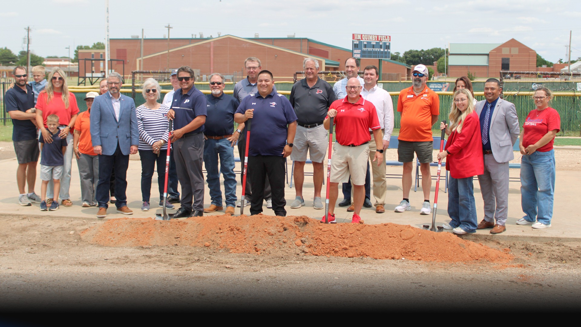 Groundbreaking ceremony shovels in dirt held by Jim Walker, Jared Mayeda, and others