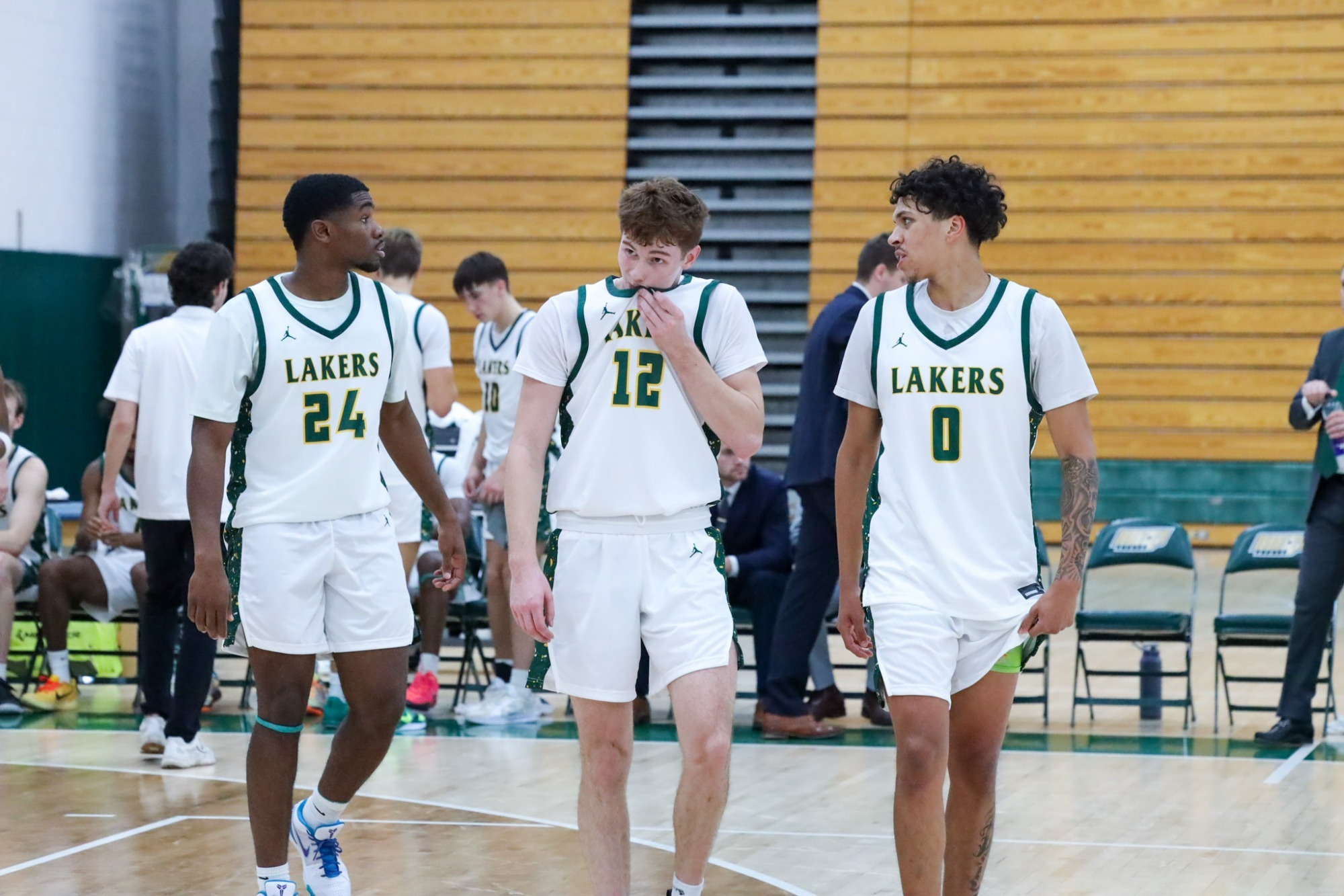 three mens basketball players 