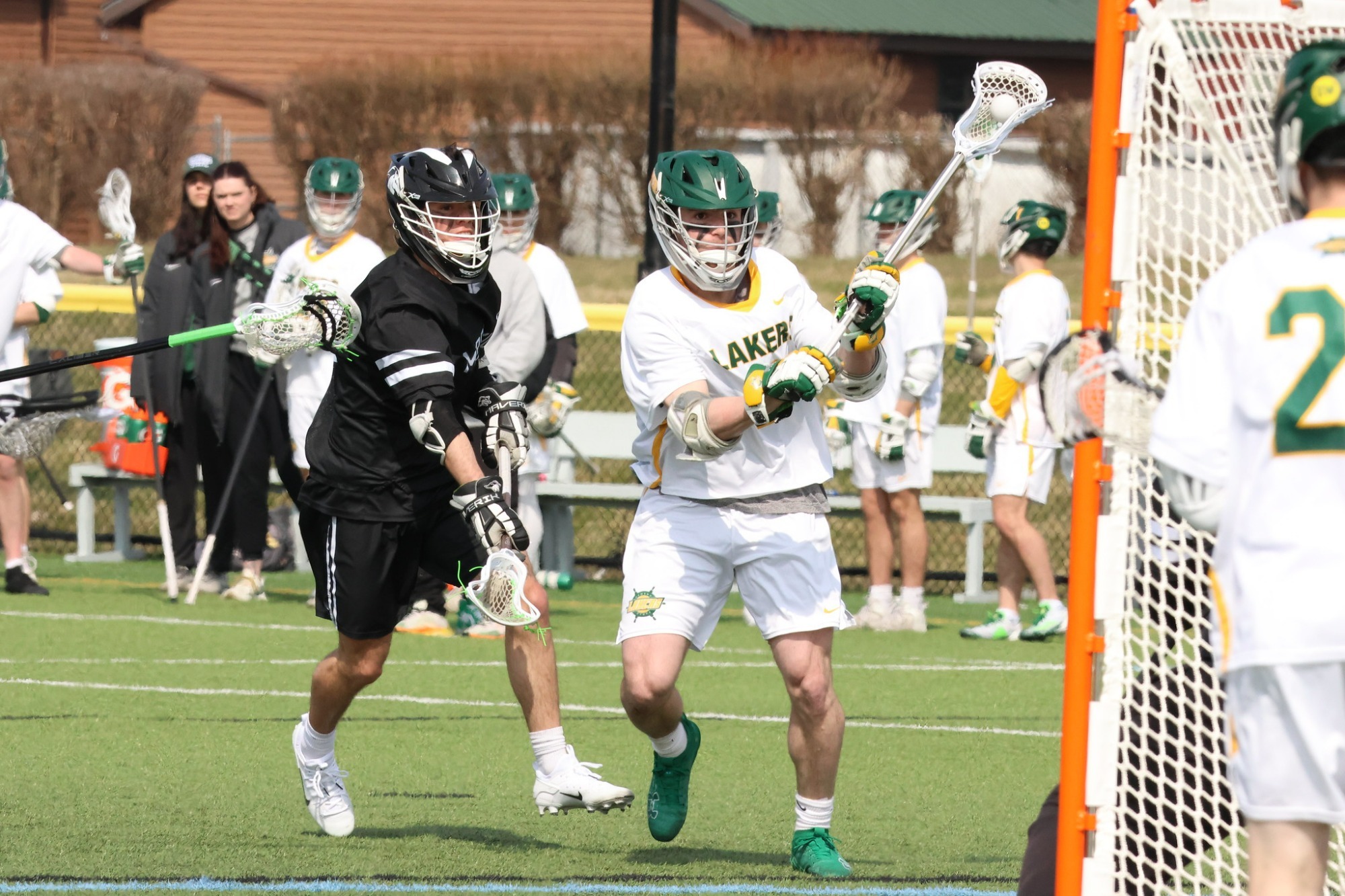 Mens lacrosse player trying to shoot a goal