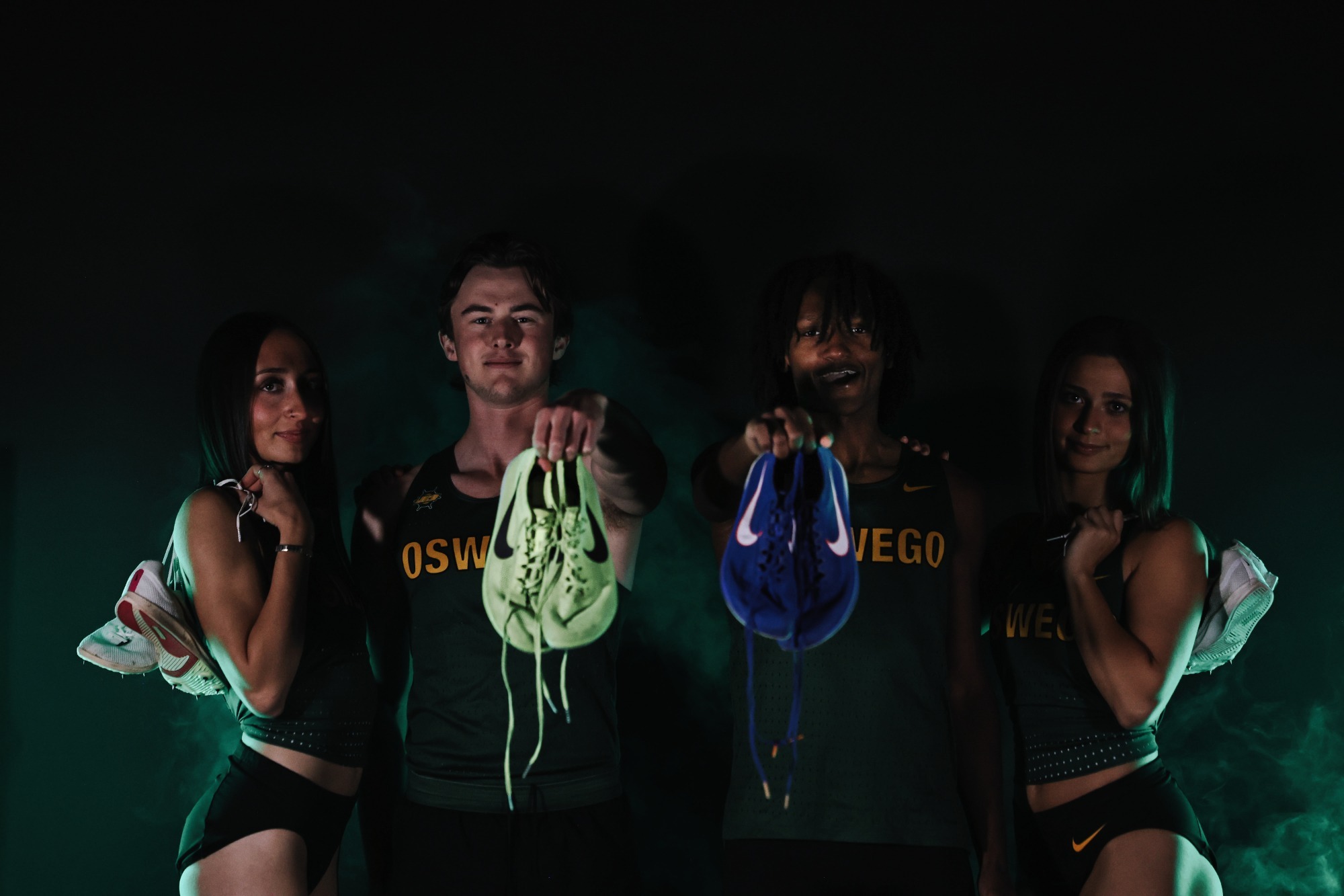 4 thrack and field athletes posing