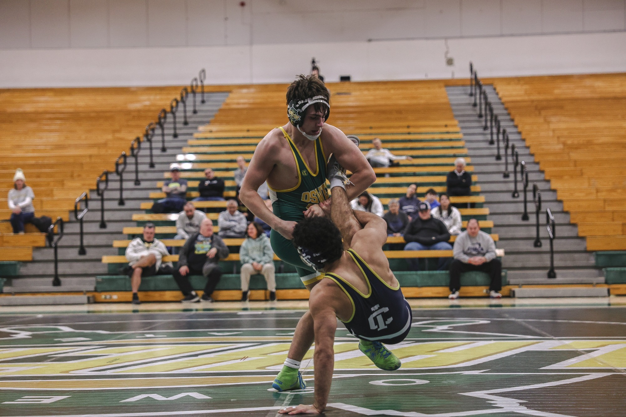 mens wrestler performing a take down