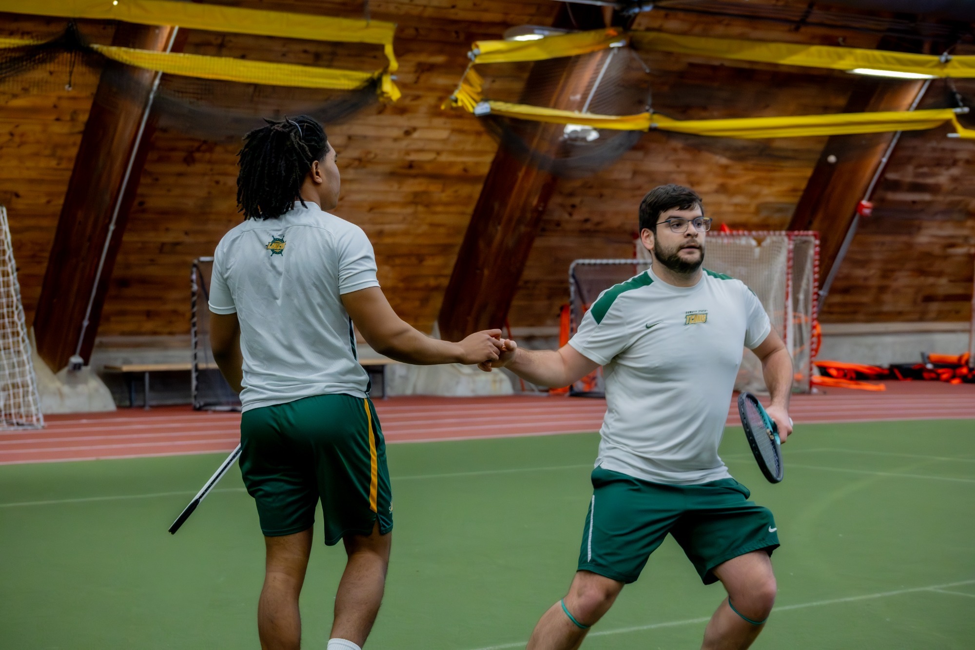 mens tennis doubles team high fiving