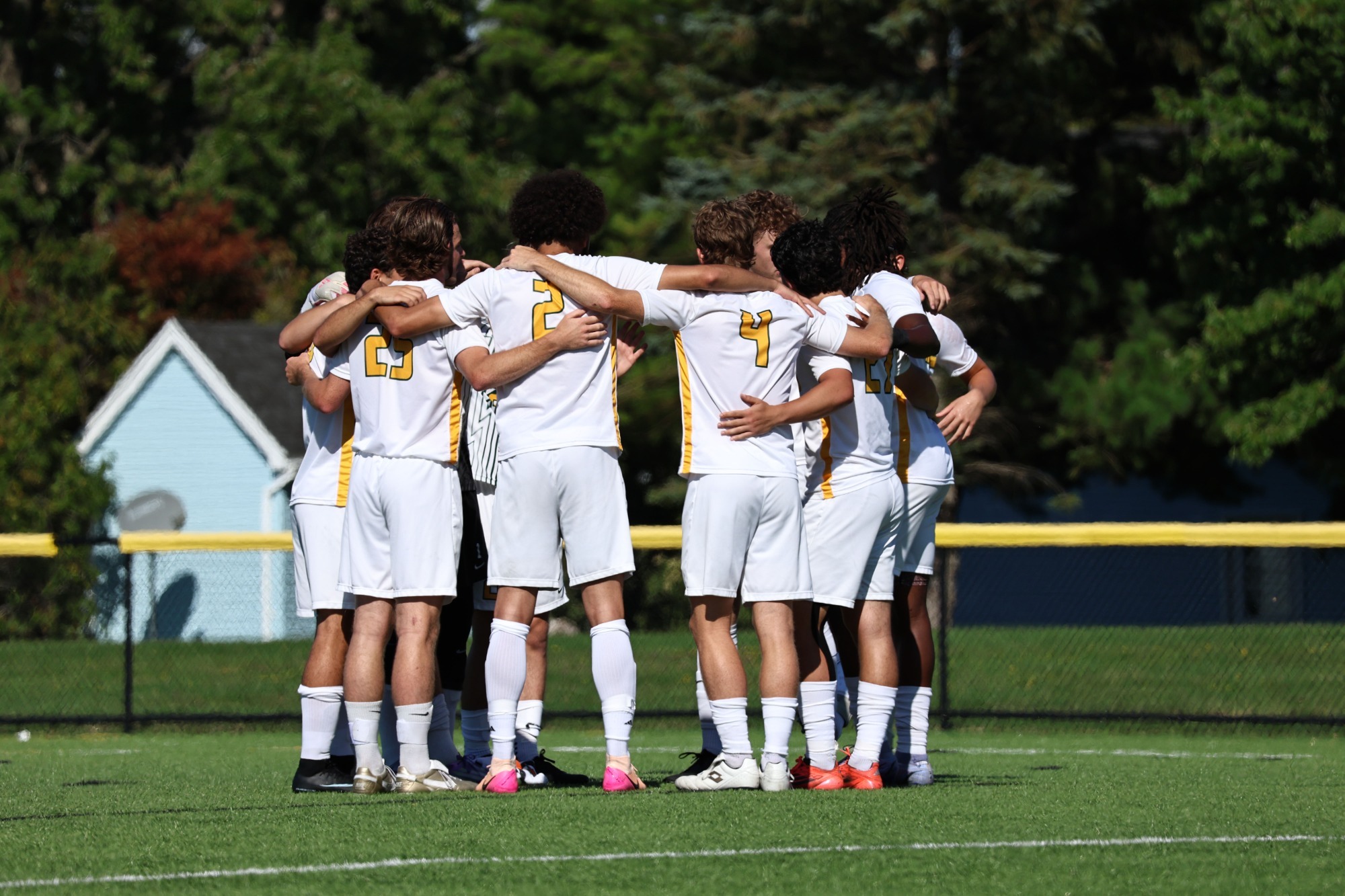 mens soccer team huddle