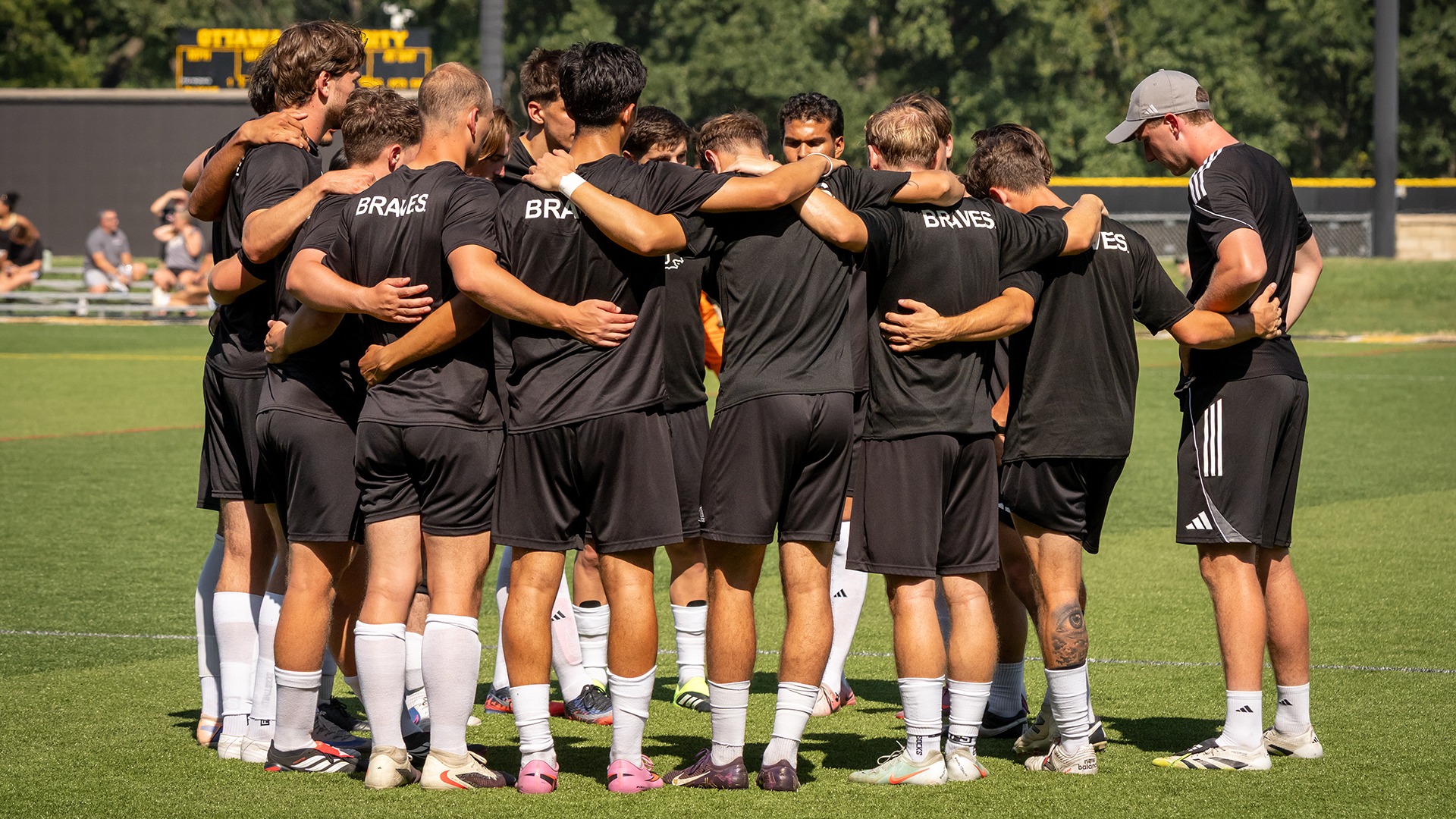 Ottawa University's Men's Soccer team in a prematch huddle.