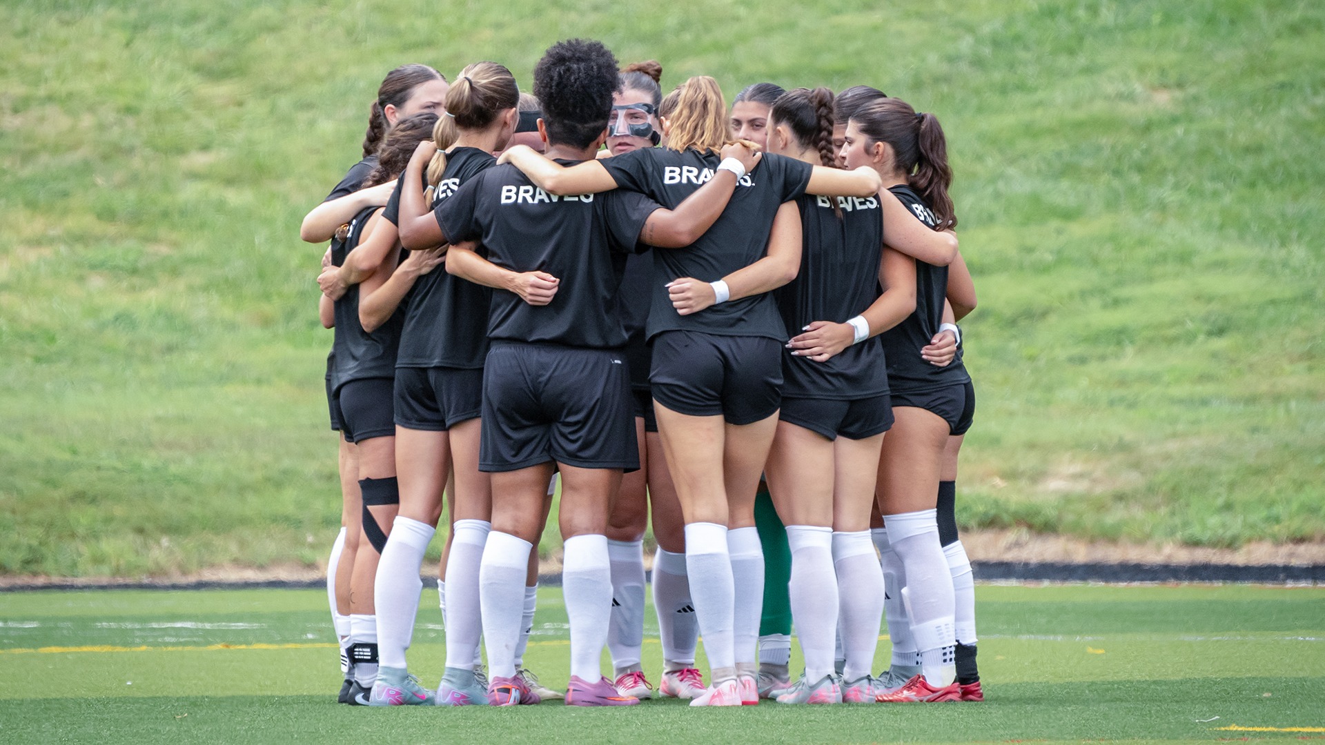 Ottawa University women's soccer team huddling before a scrimmage with Southwest Baptist University