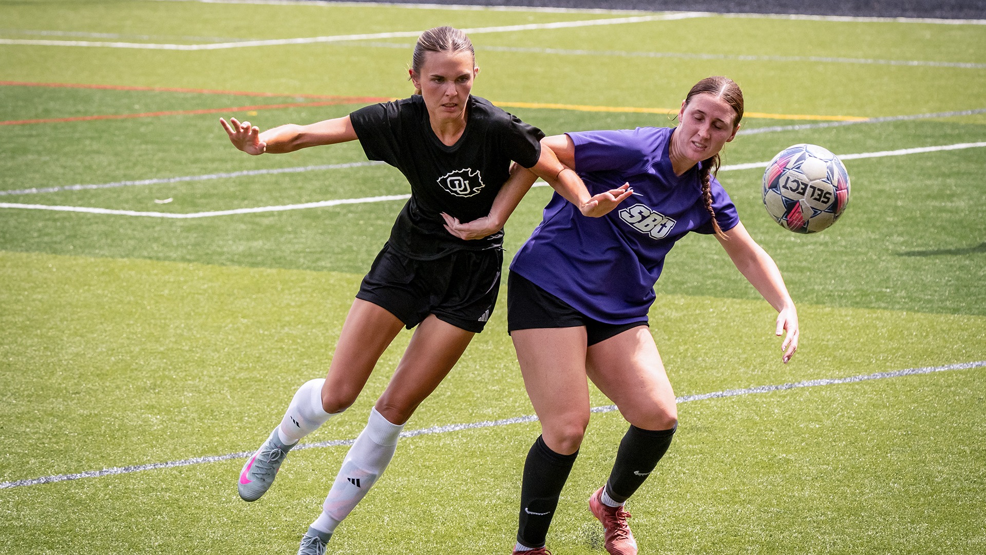 Peyton Hack battles against a Southwest Baptist University defender in a scrimmage