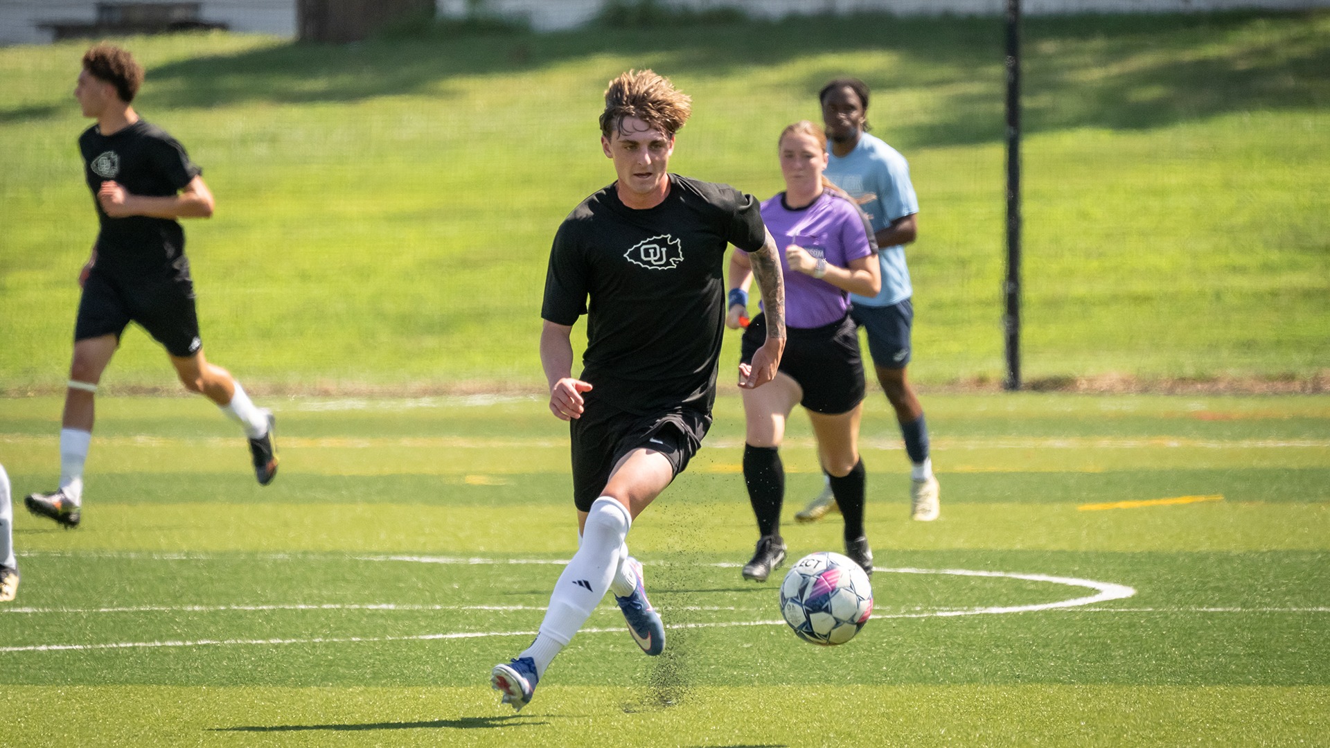 Cale Scott dribbles upfield in a scrimmage match against State Fair Community College