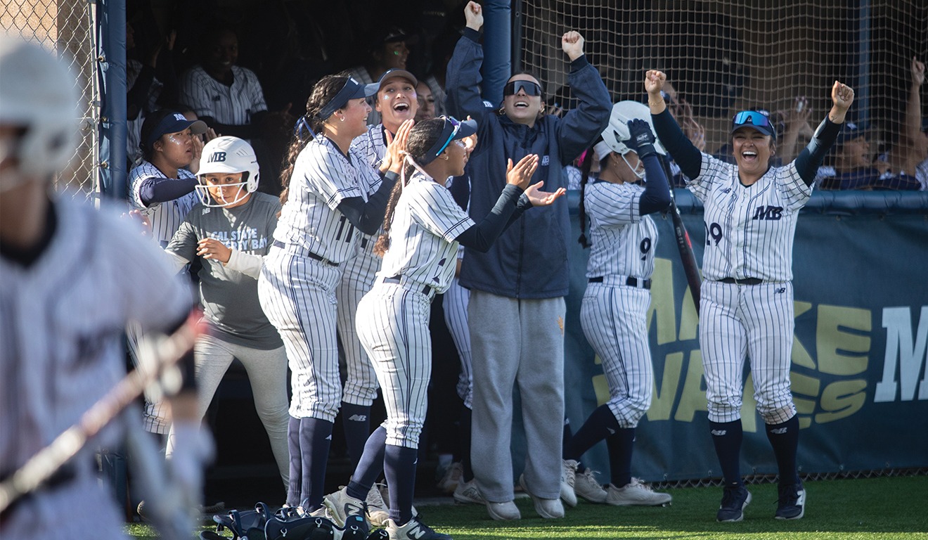 This is the photo of Otter Softball celebrating a good play. 