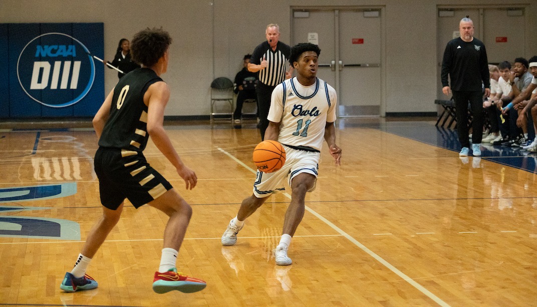 Devin McCaine (#11) brings the ball upcourt