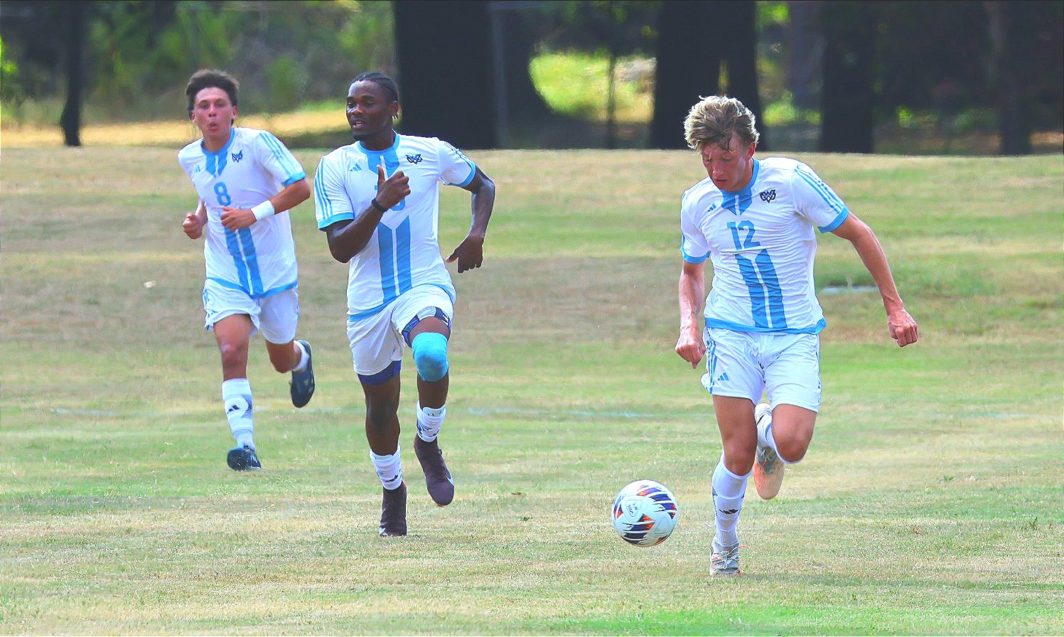 Talon Burdett (12) dribbles the ball
