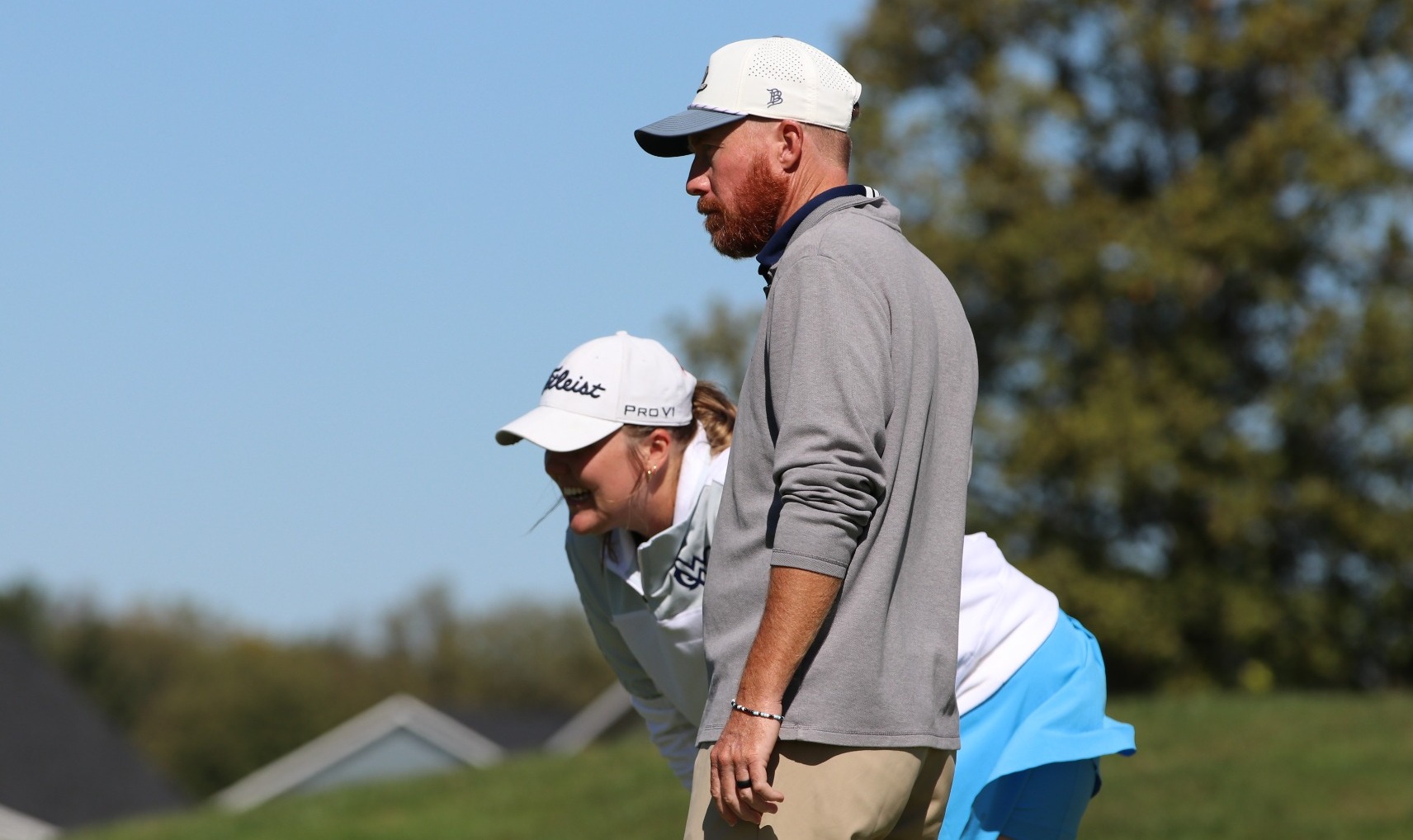 Addi Campbell and coach Benji Williams look over a putt