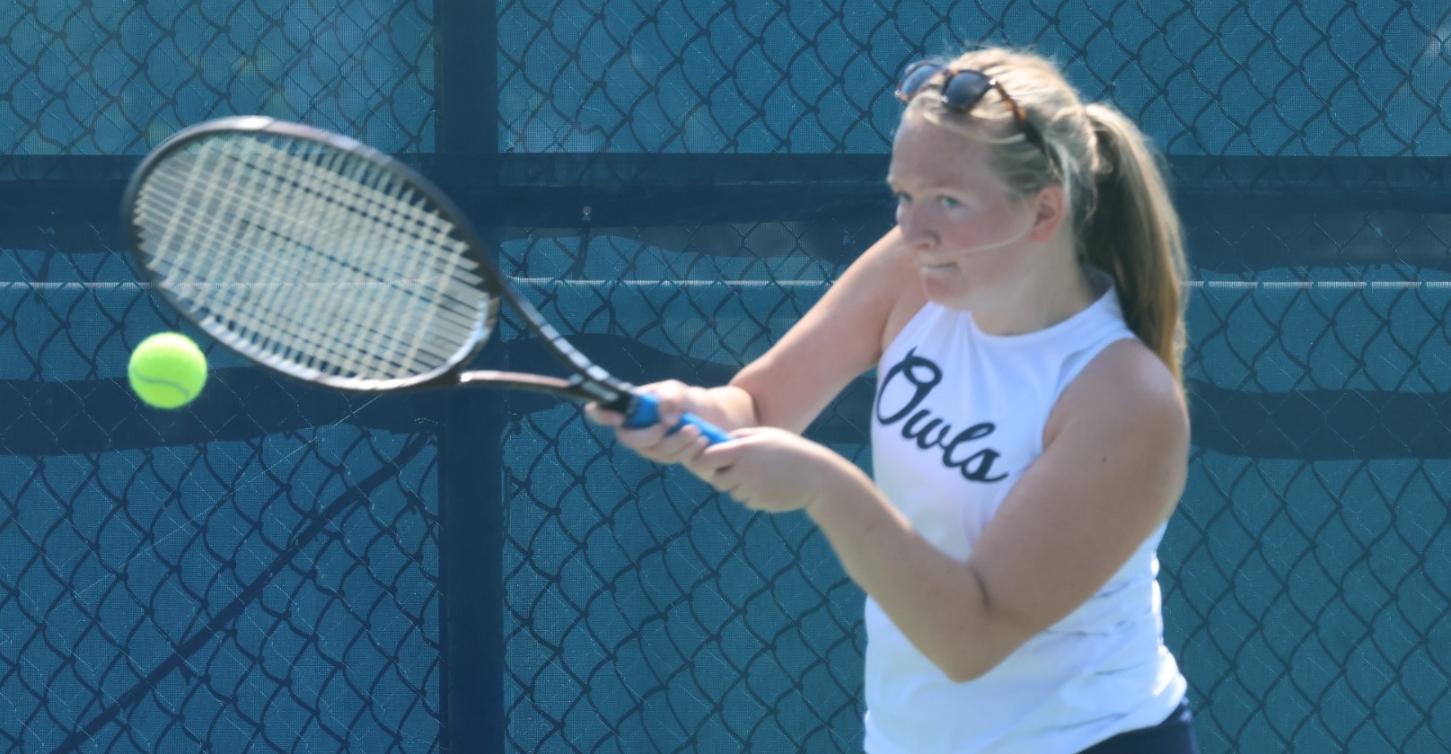 Women's tennis player Alaina Mathis returns a shot