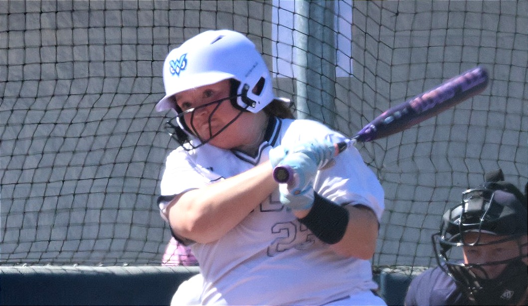 Brooklyn Rhodes swingi9ng a bat