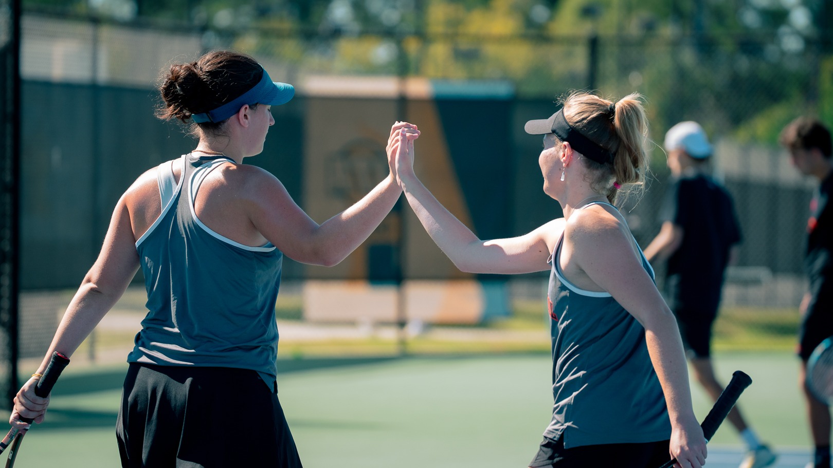 Greta Nagy and Elina Shalaev high fiving after winning a point