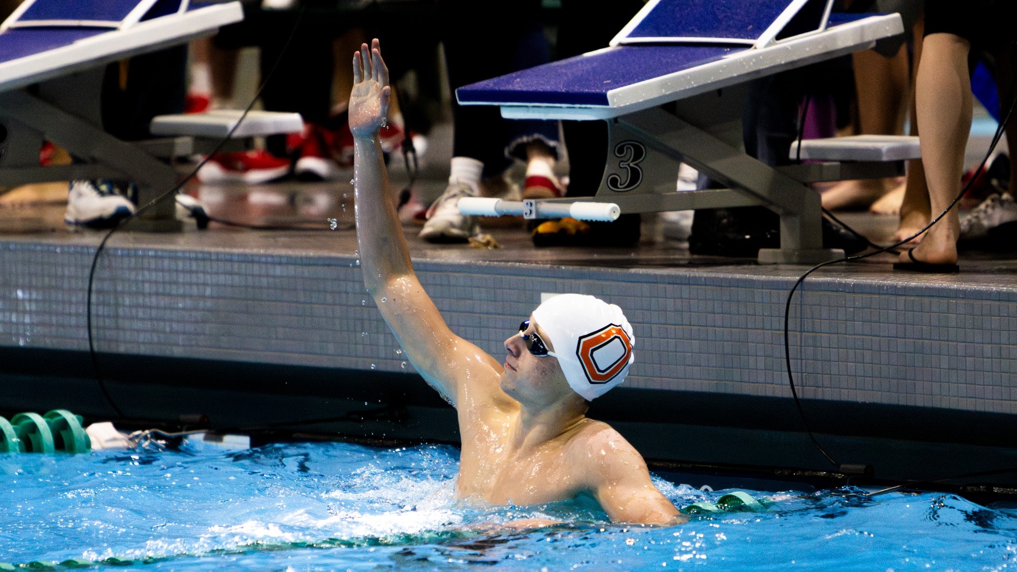 Connor Grant celebrates his SCIAC Champion finish in the 200 Free by waving his hand in the air. Grant is the first men's SCIAC champion in 10 years.