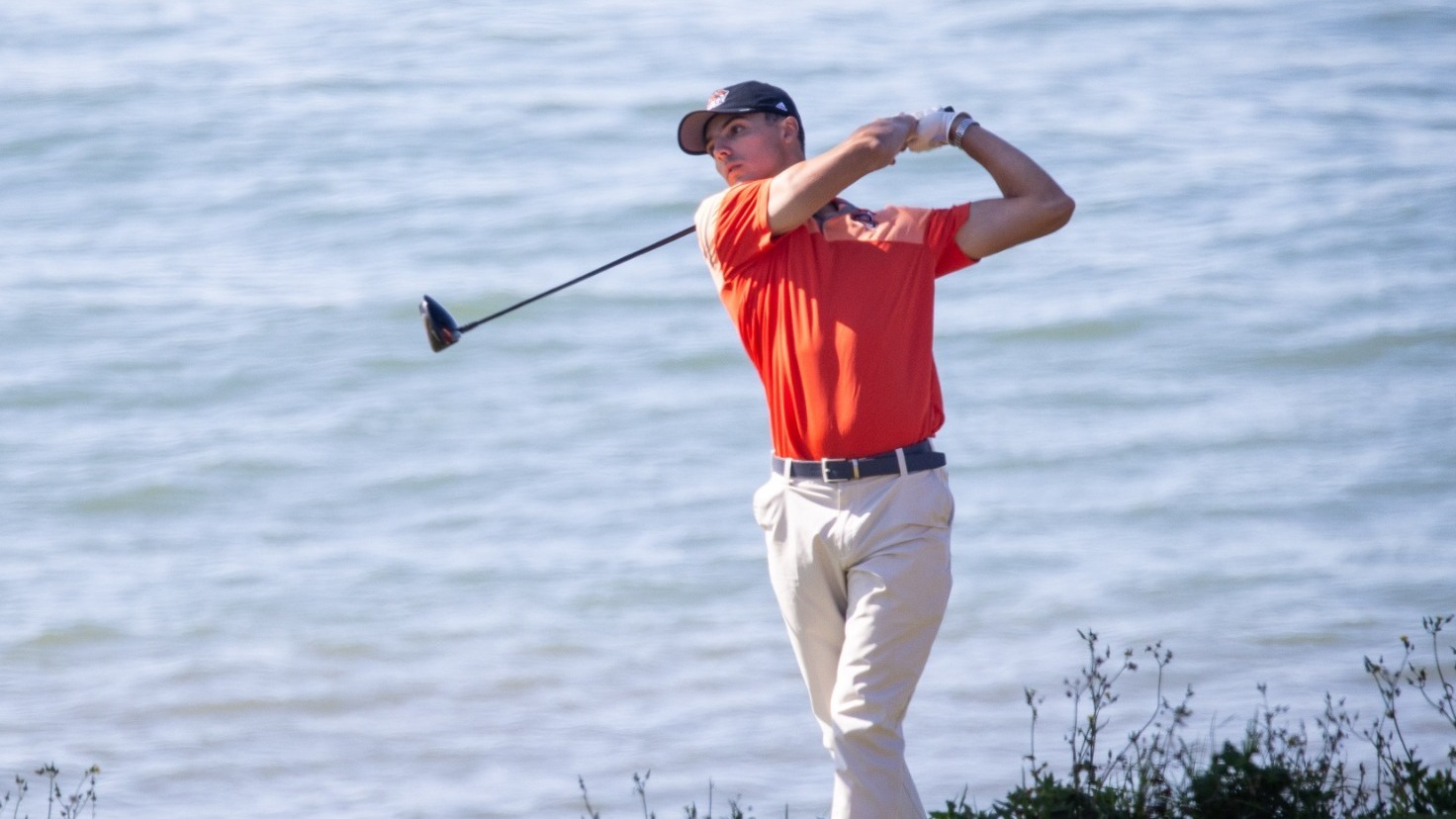 Owen Wolak takes a tee shot by the water