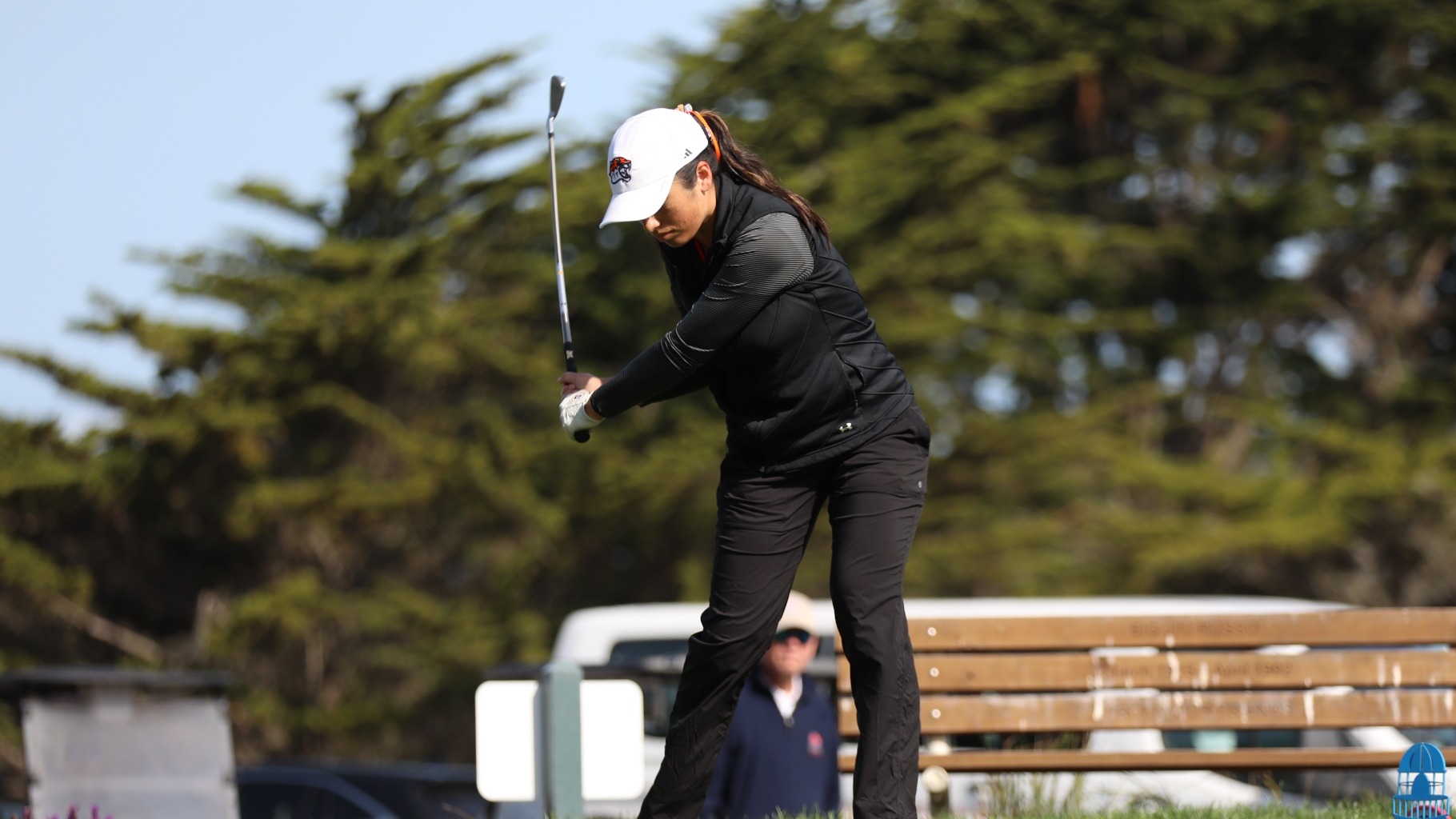 Rachel Aujero swings an iron on a tee shot