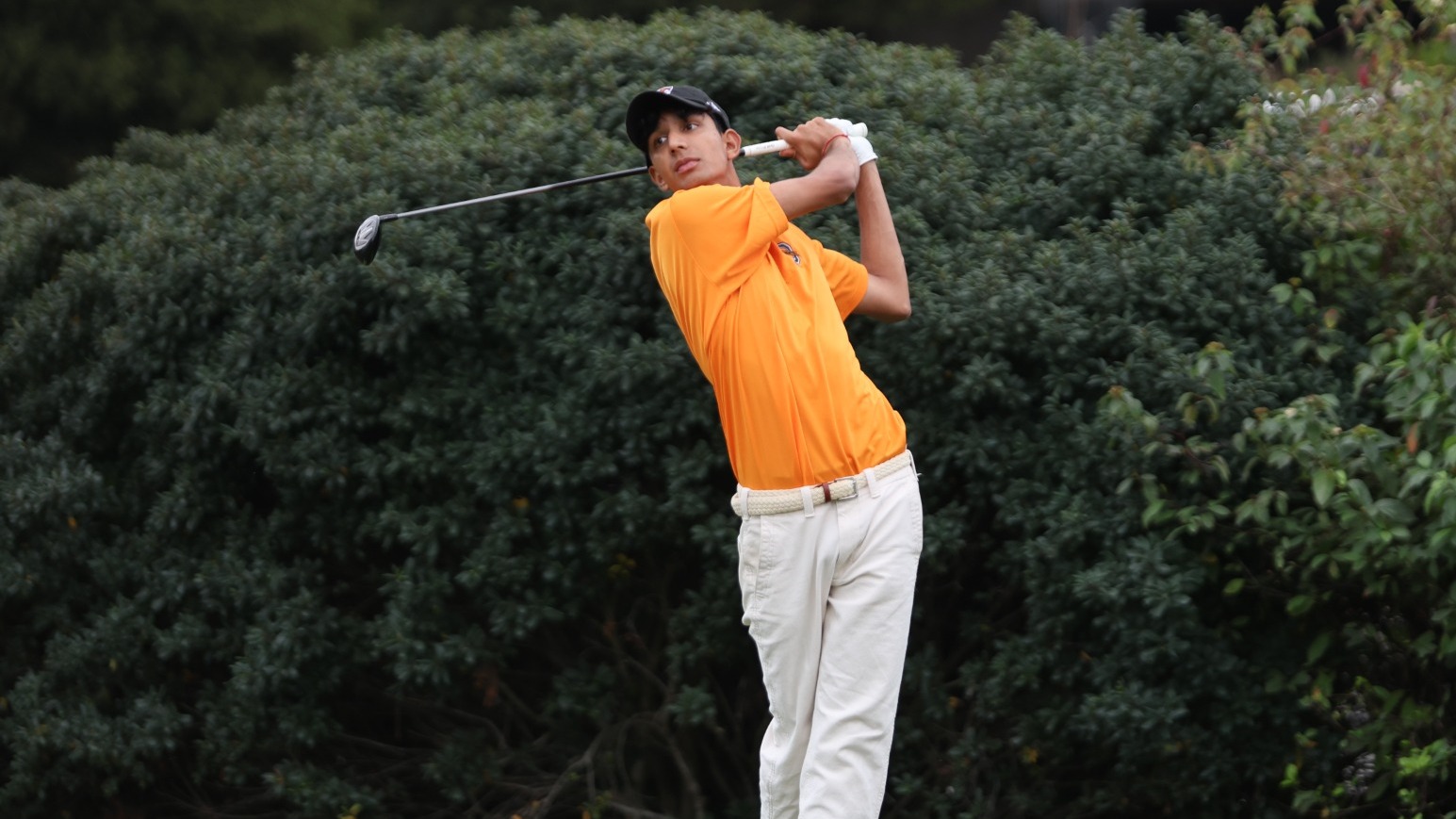 Amaan Kanji follows through after a tee shot