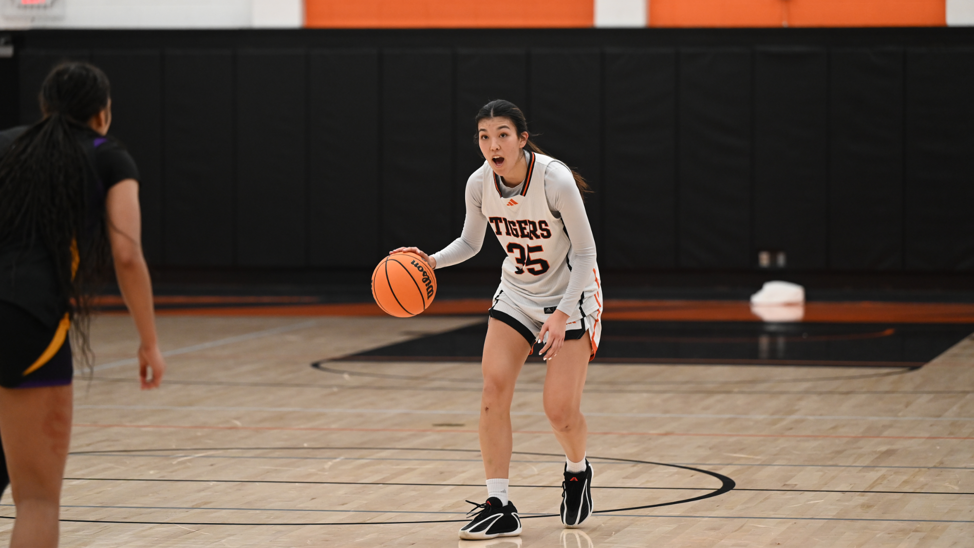 Paige Yasukochi dribbles the ball up the court