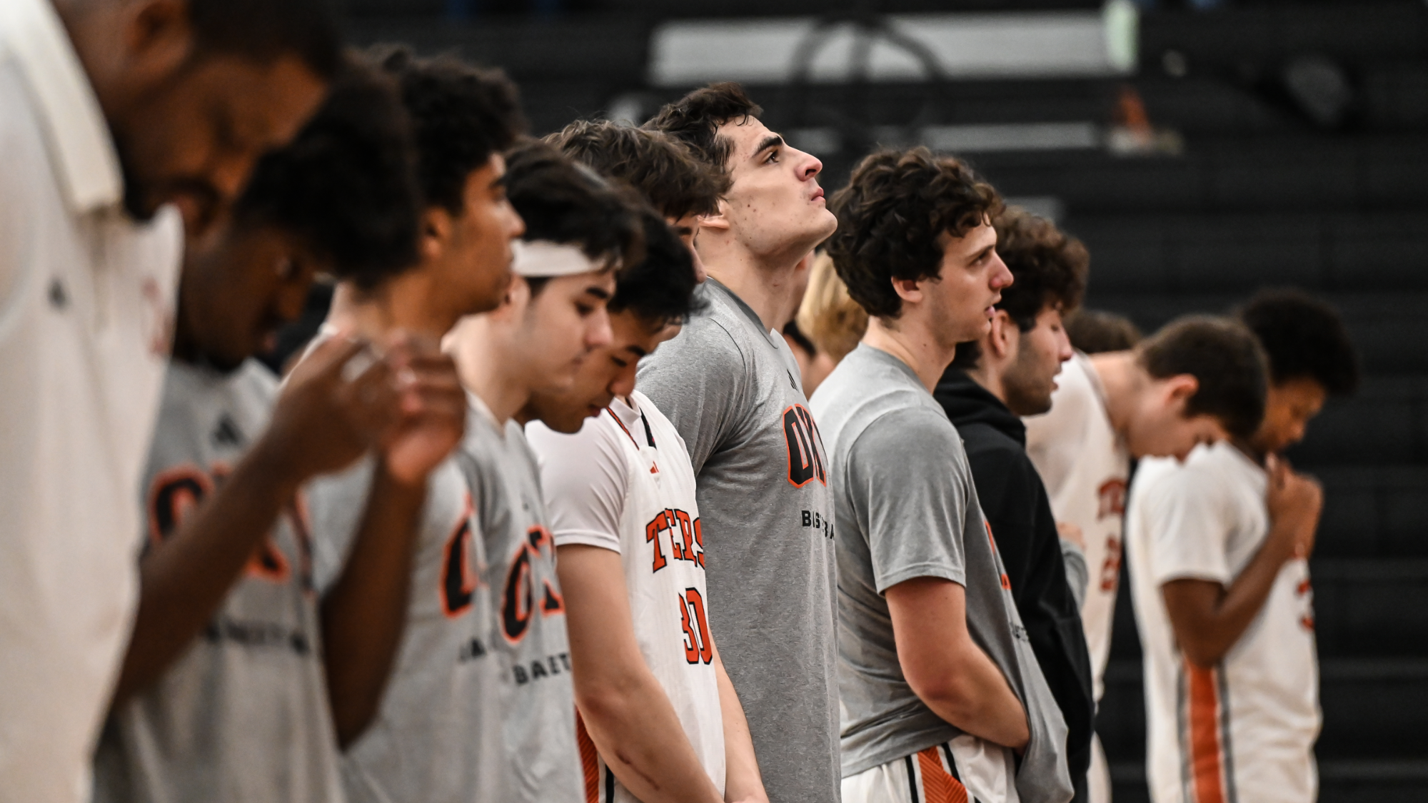 Chase Miller and the basketball team stand ready for the national anthem