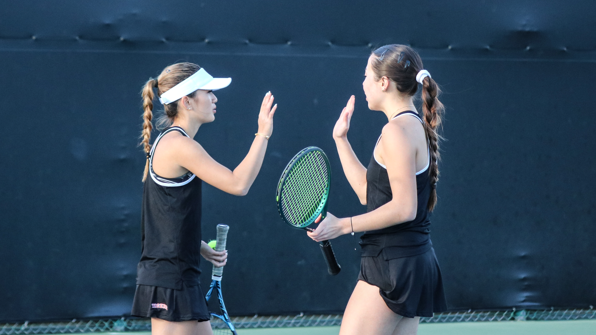 Catelyn Isman and Nicole Anderson high fiving in doubles
