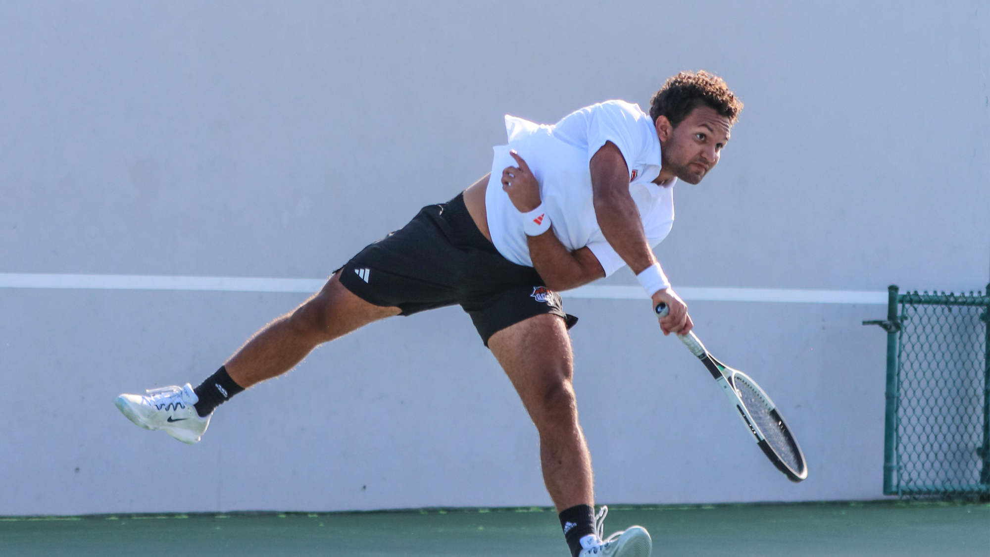 Ben Burrows hits a serve