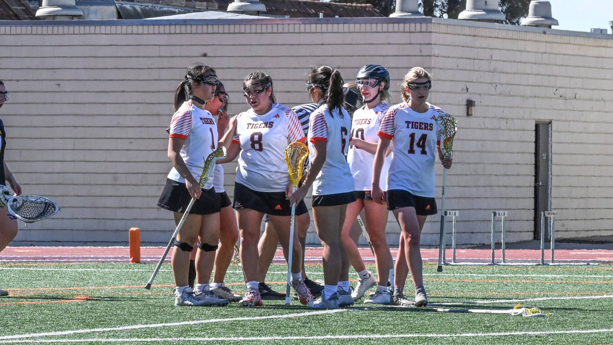 Women's Lacrosse huddles after a goal