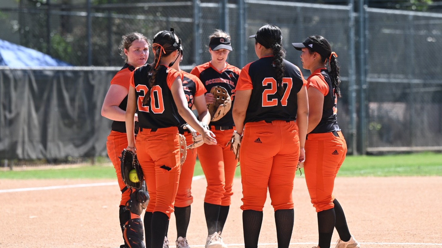 Softball huddles at the circle
