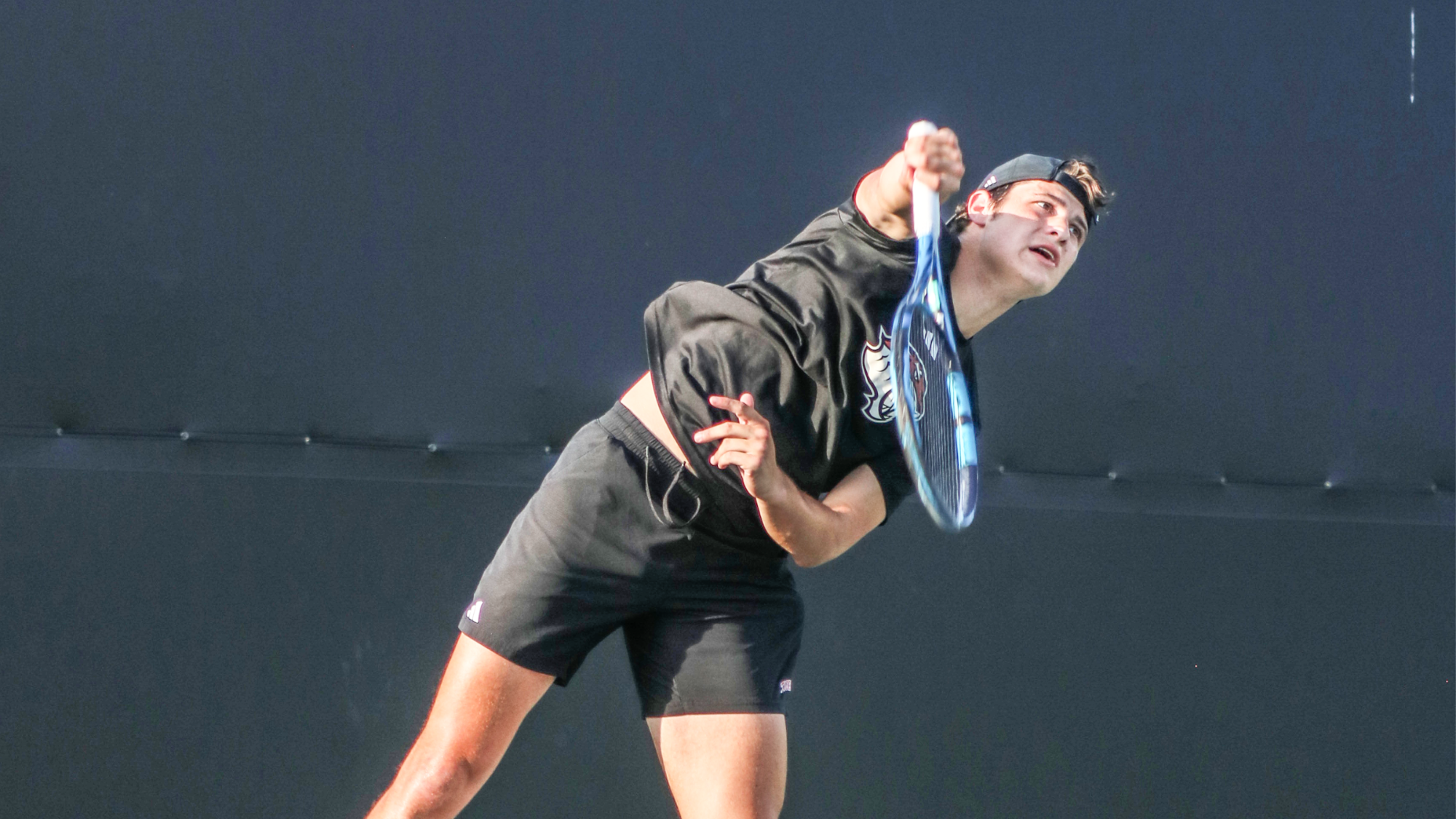 Jack Yurich hits a serve