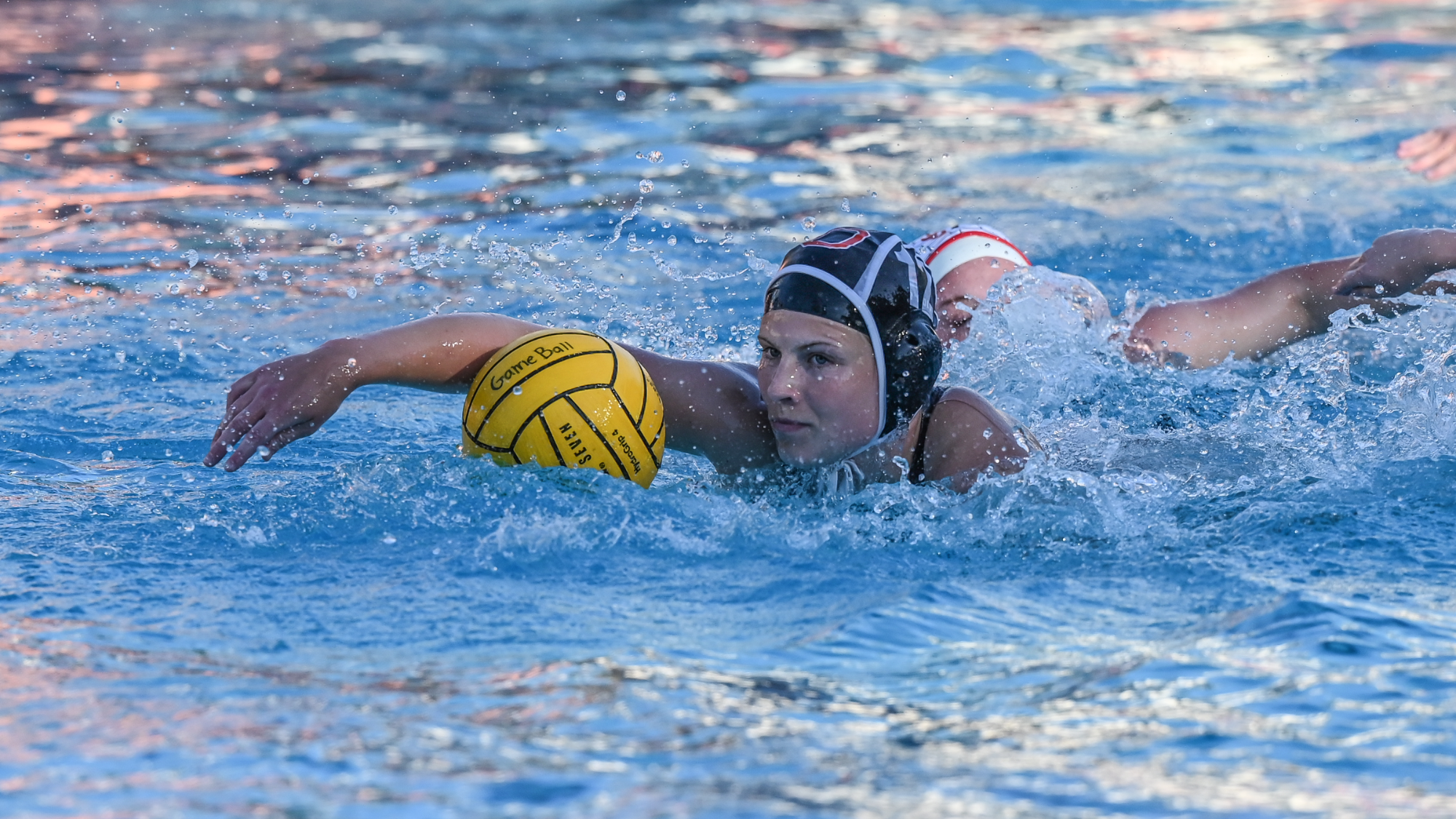 Bella Wilde swimming with the ball down the pool