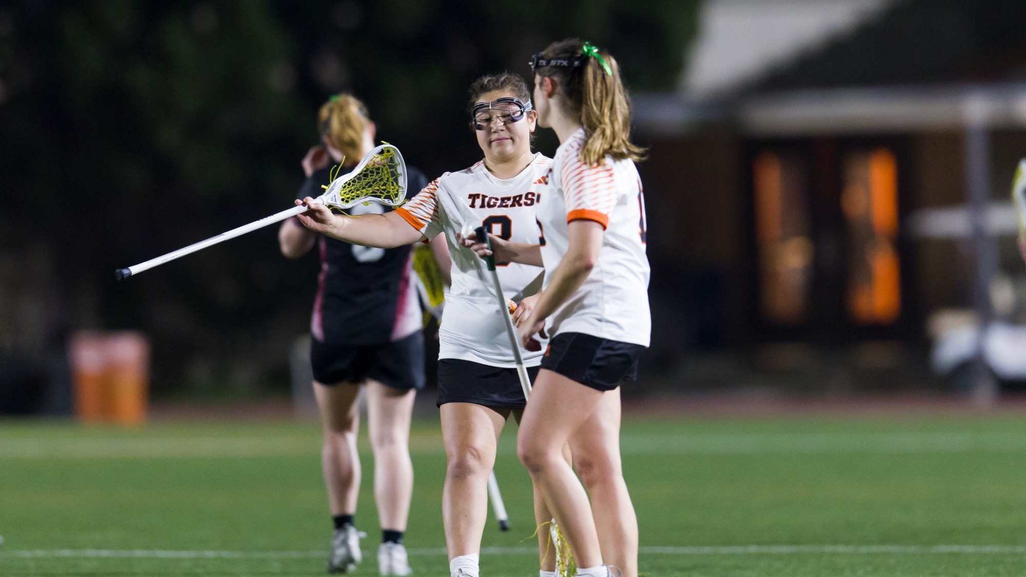 Olivia Okamoto giving a stick high five