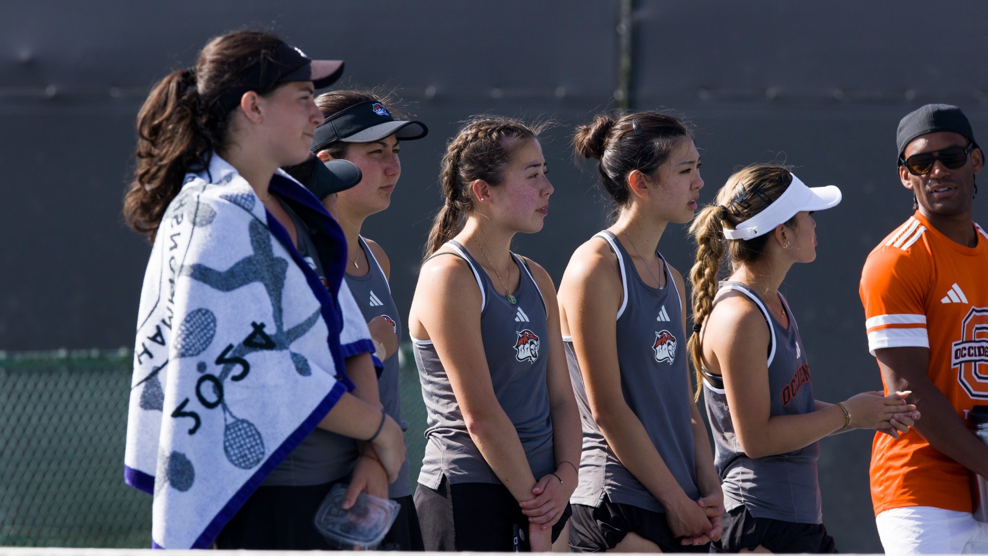 women's tennis team looks on