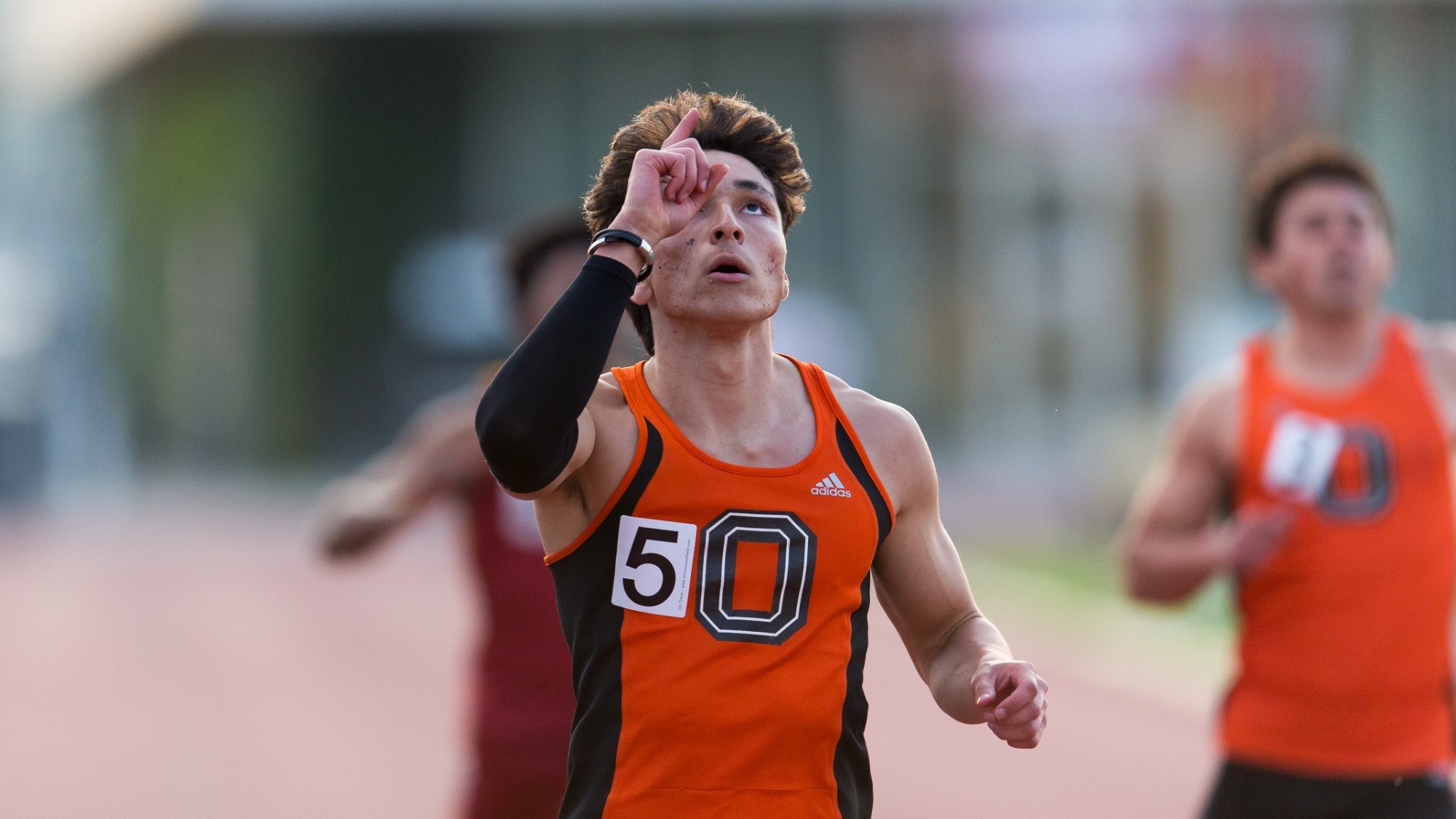 Shane Kawakami-Williams points to the sky after finishing race