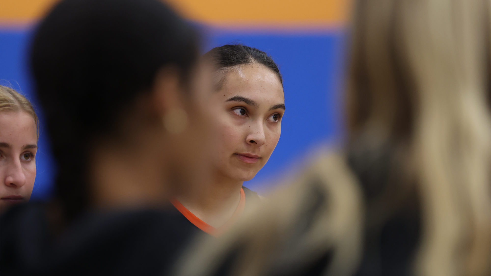 Katelyn Cajigas looks on as women's volleyball talks in the huddle