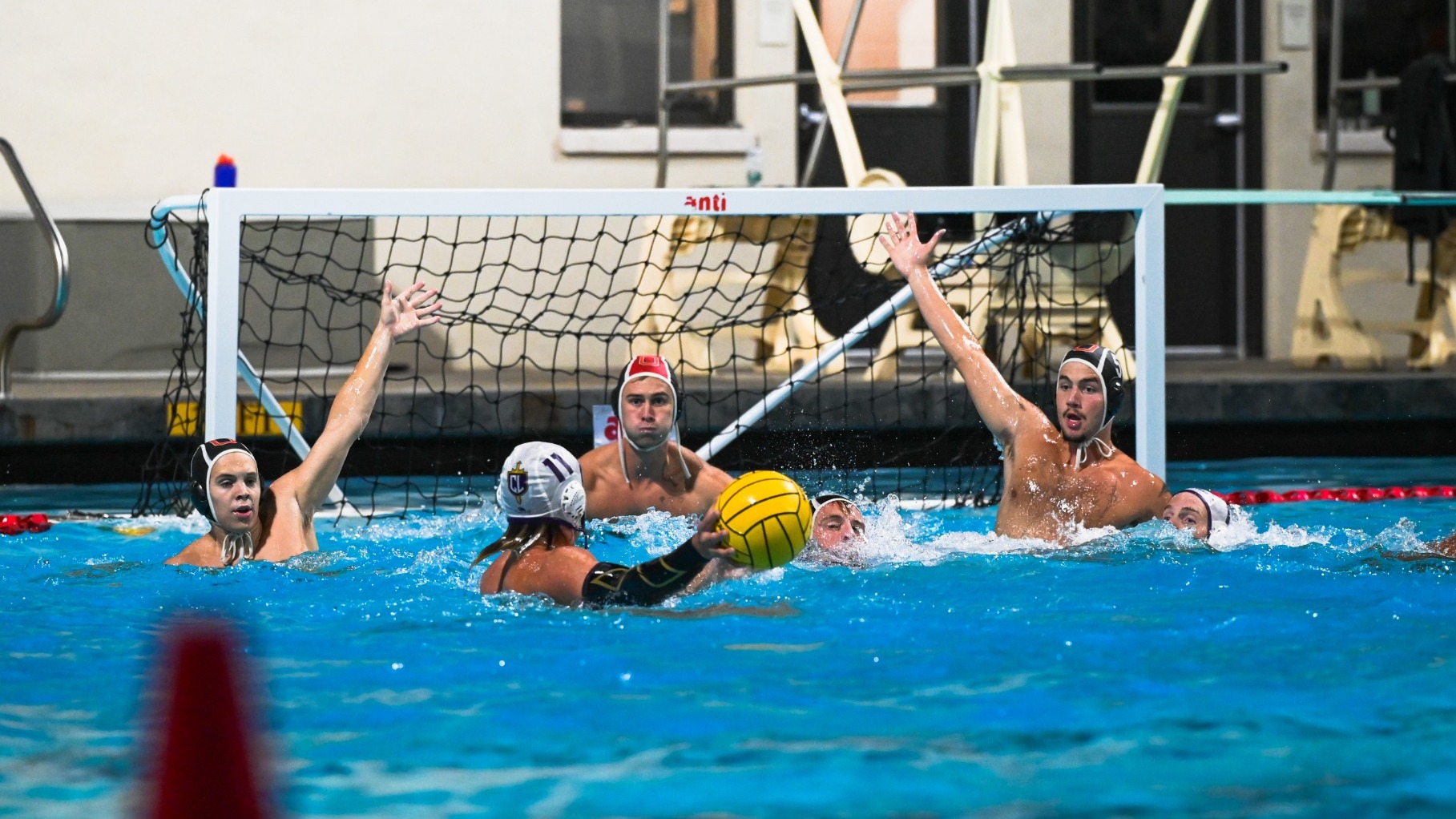Will Garcia gets ready to make a save as Lars Schubert and Atticus Wahab-Holles defend the power play