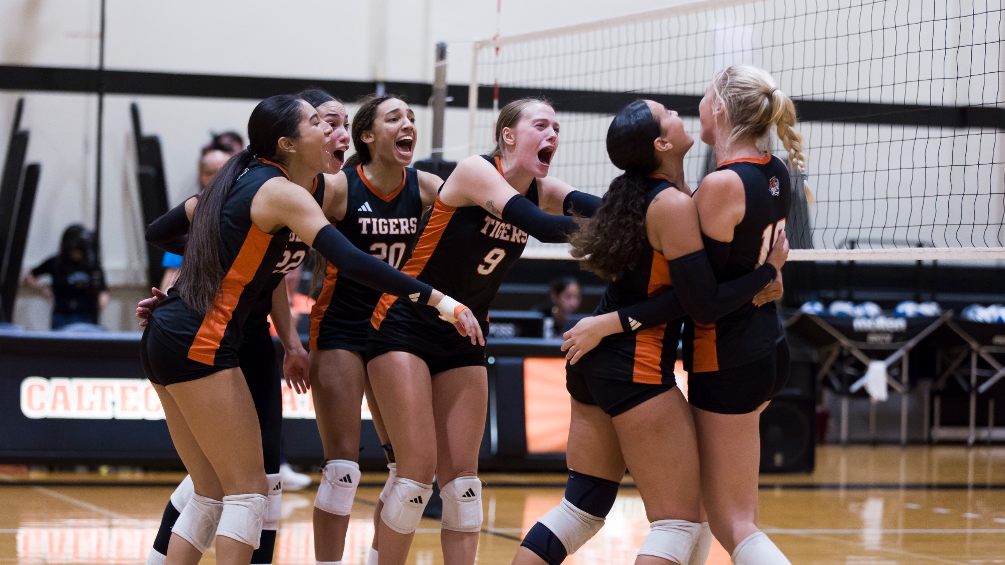 Women's volleyball celebrates winning a point