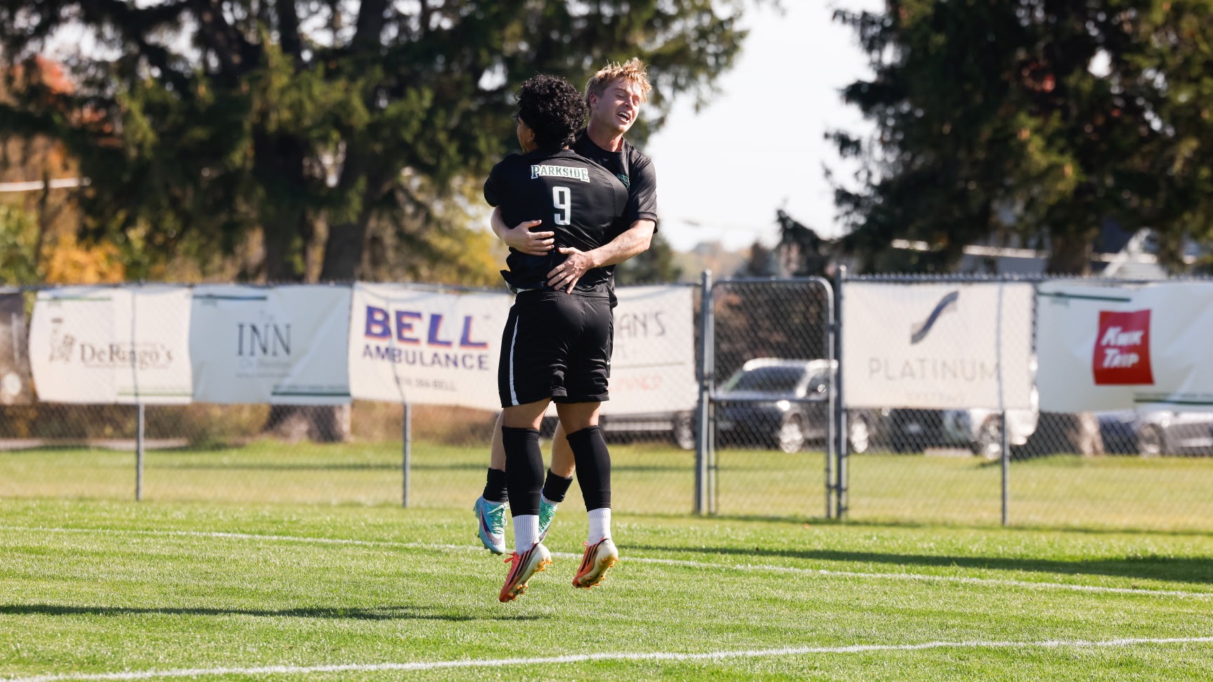 Soccer players hugging 